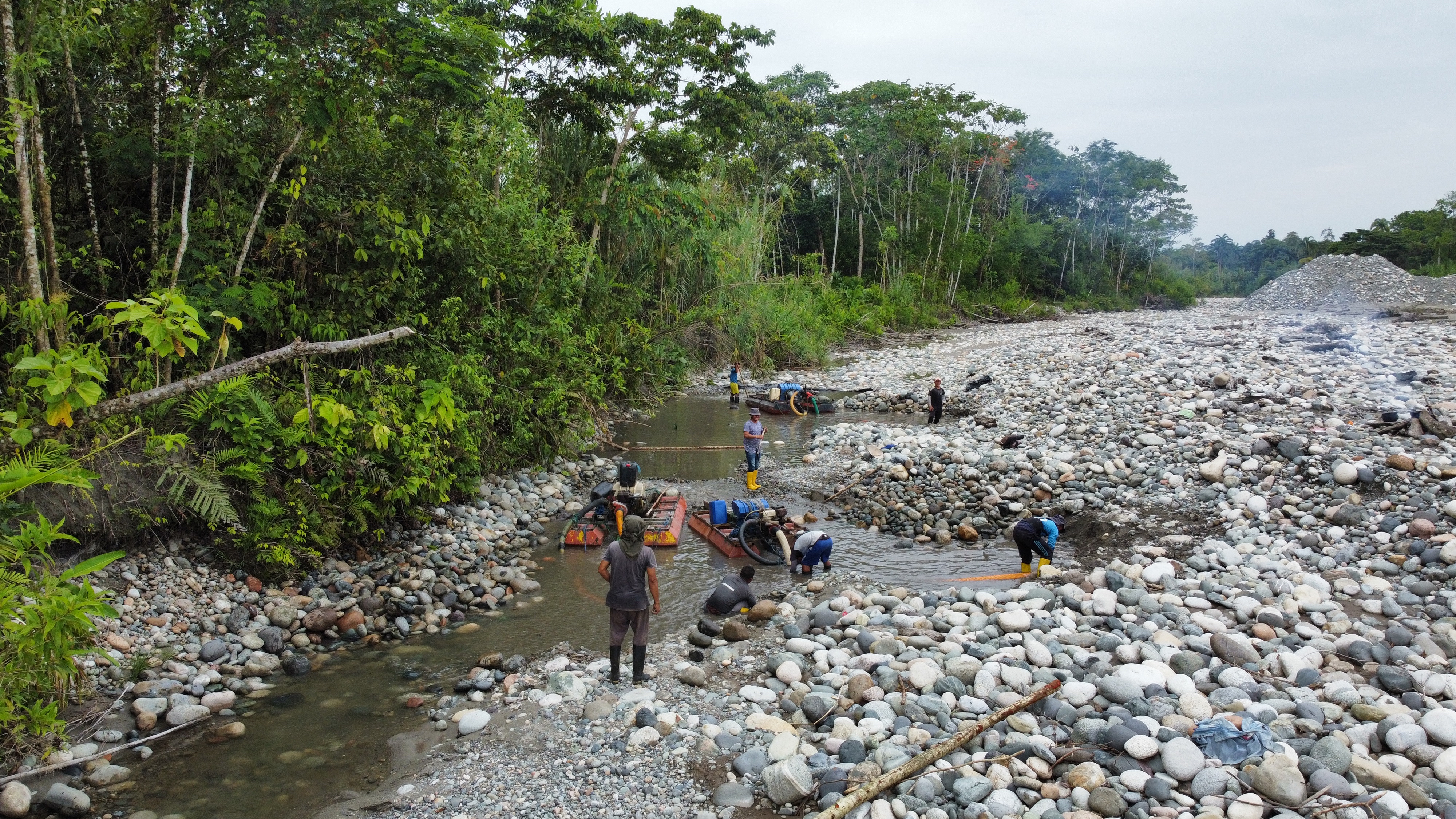 Miners work at a site in Tena, Ecuador