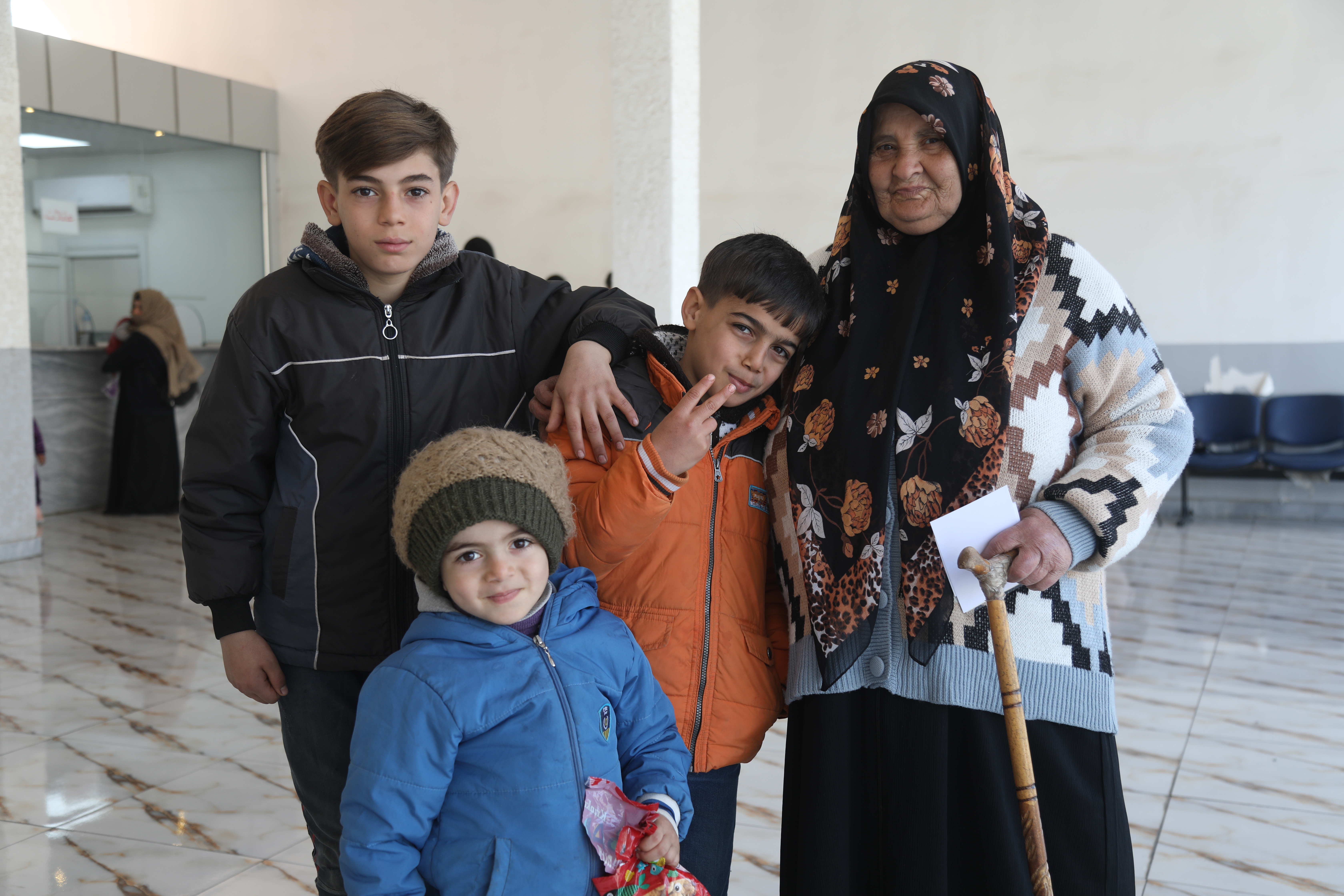 Um Yaser with her family after crossing the border