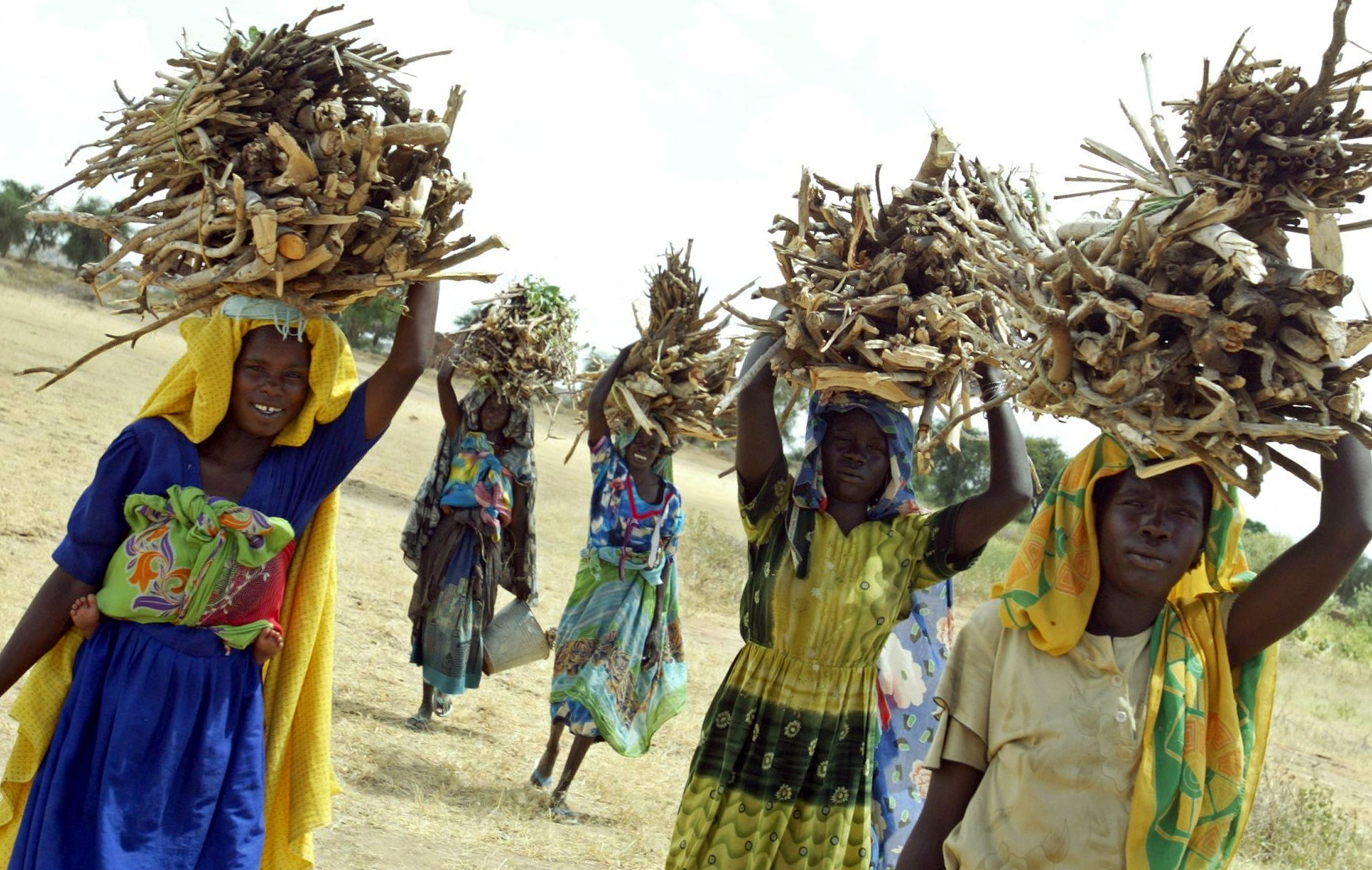 Displaced women from Sudan’s Fur tribe flee their homes after fighting tore through Darfur