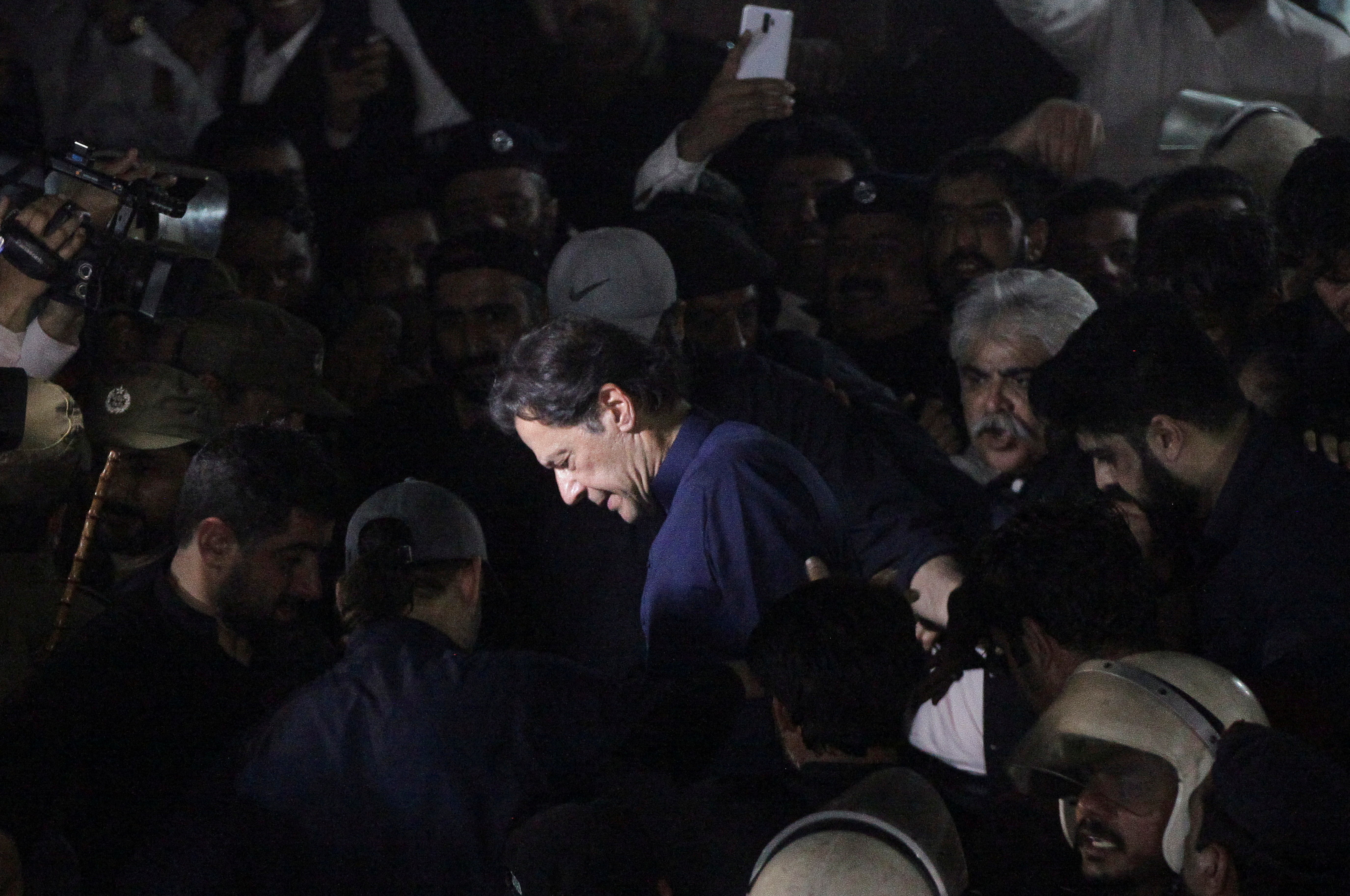 Pakistan's former Prime Minister, Imran Khan, along with his supporters walks as he leaves the district High Court in Lahore