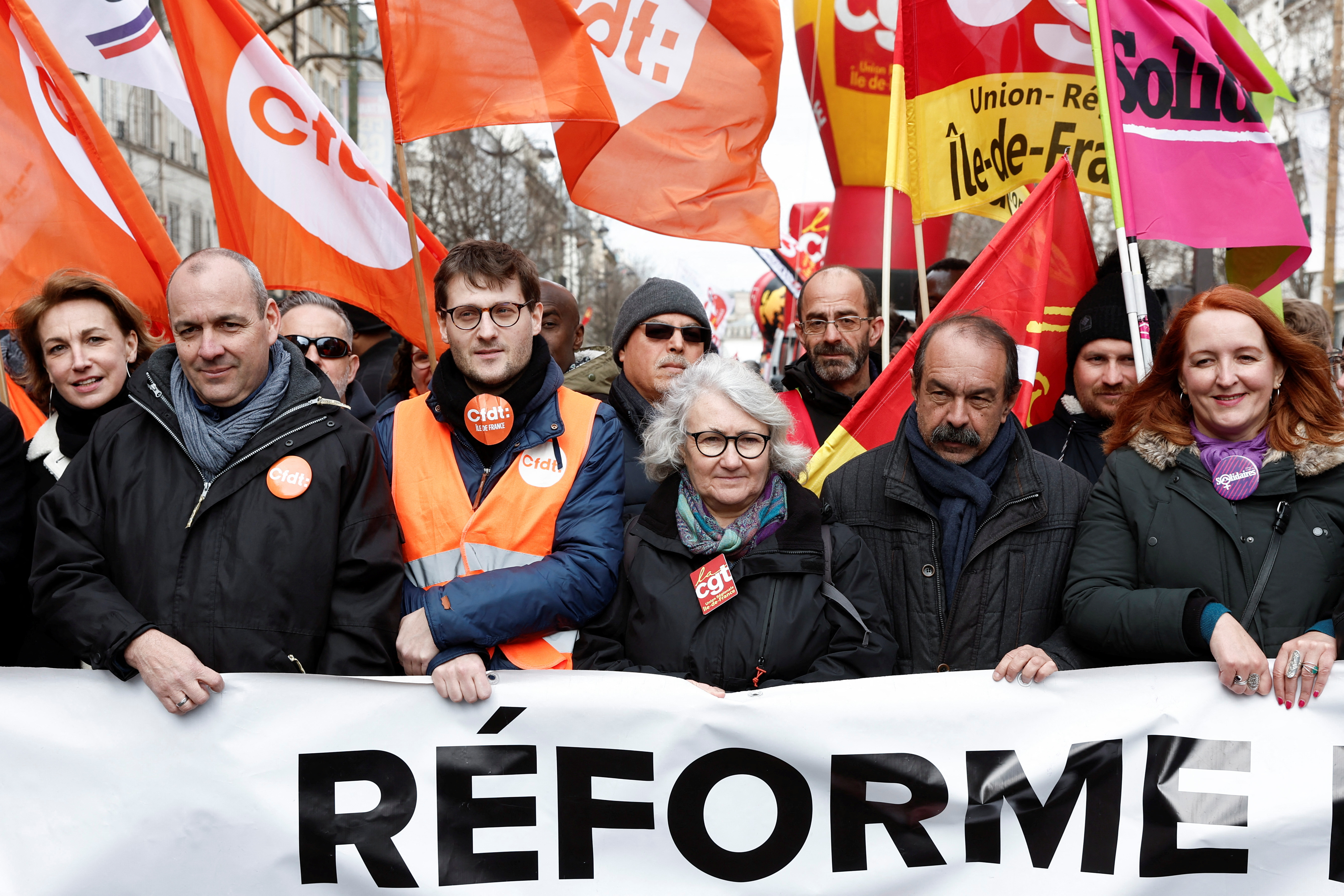CGT union leader Philippe Martinez and Laurent Berger, secretary general of French Democratic Confederation of Labour (CFDT), hold a banner with other demonstrators in Paris, France, March 11, 2023