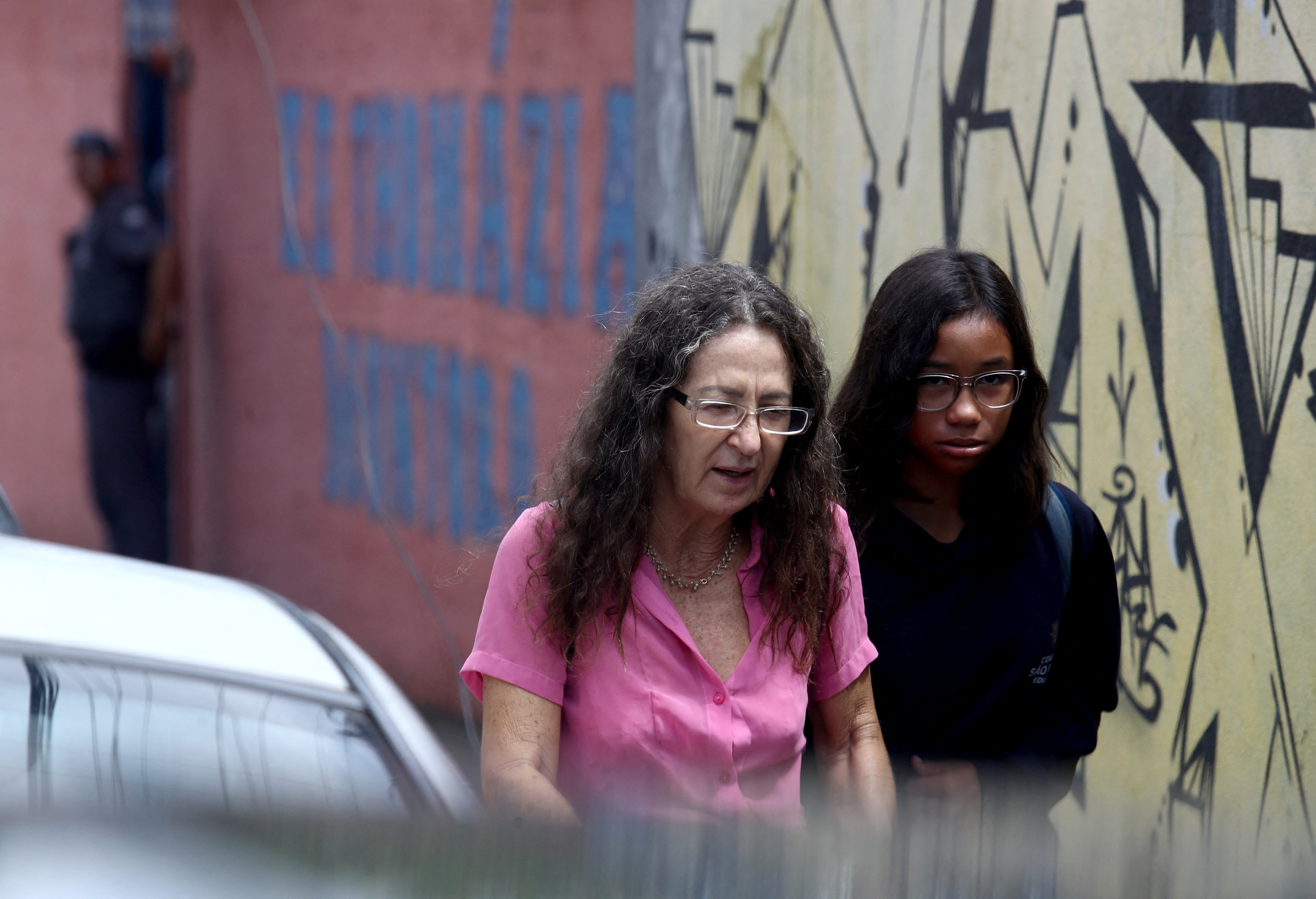 Students and adults walk away from Thomazia Montoro, where a teacher was stabbed to death on Monday morning