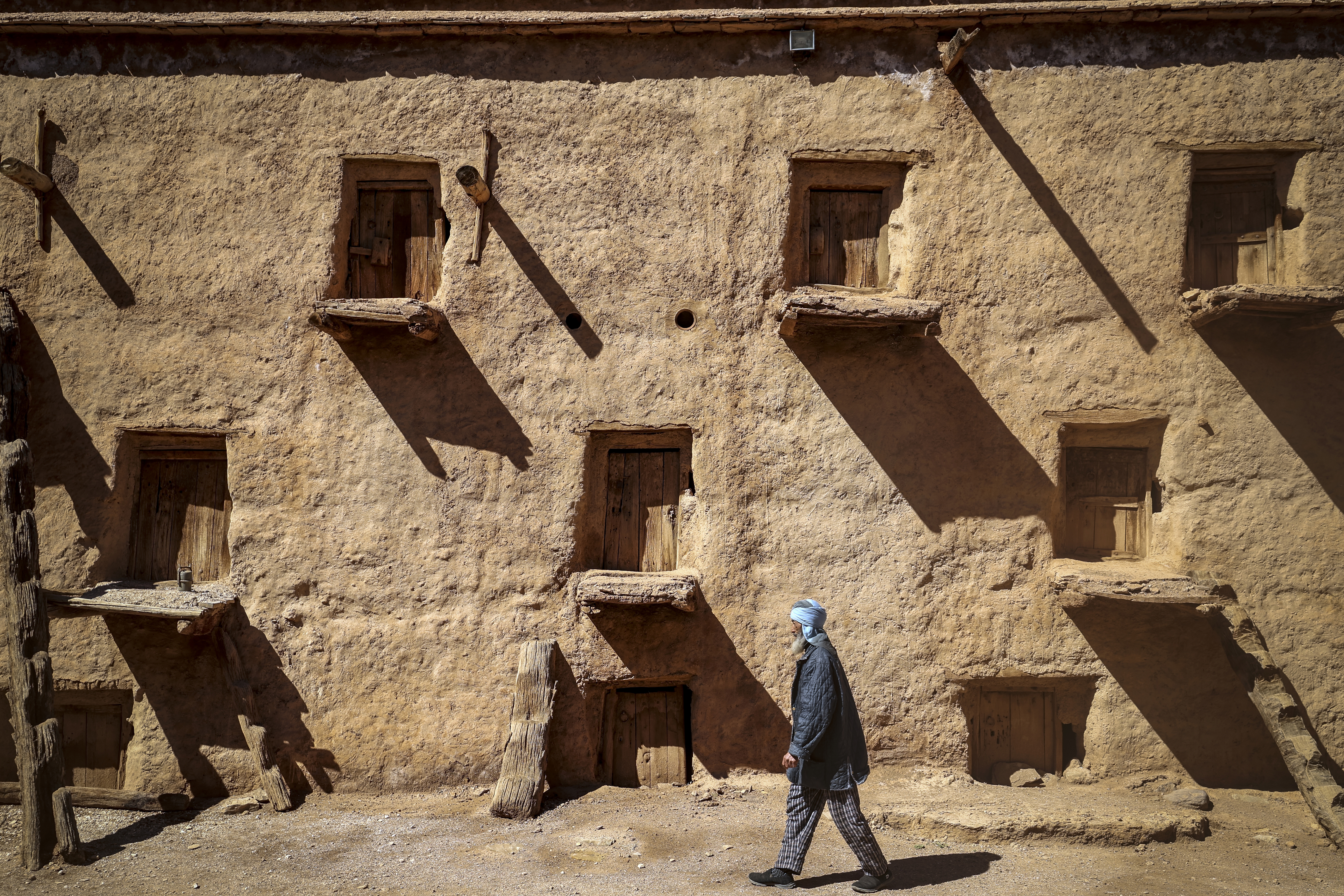 Guardian Lahcen Boutirane walks at the ancient collective granary of Ait Kine