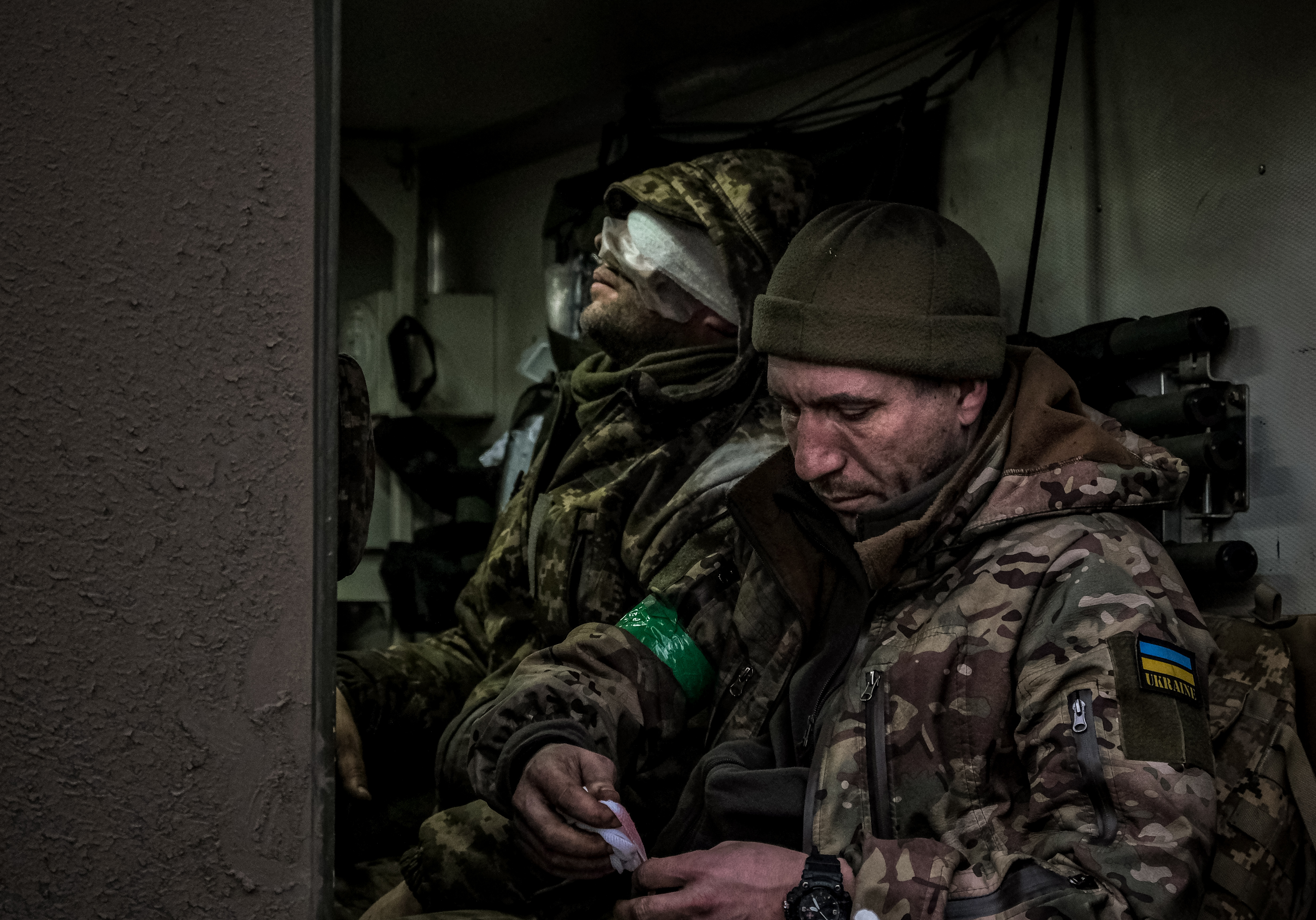 A wounded Ukrainian soldier in an armoured personnel carrier being evacuated from the front line in Bakhmut