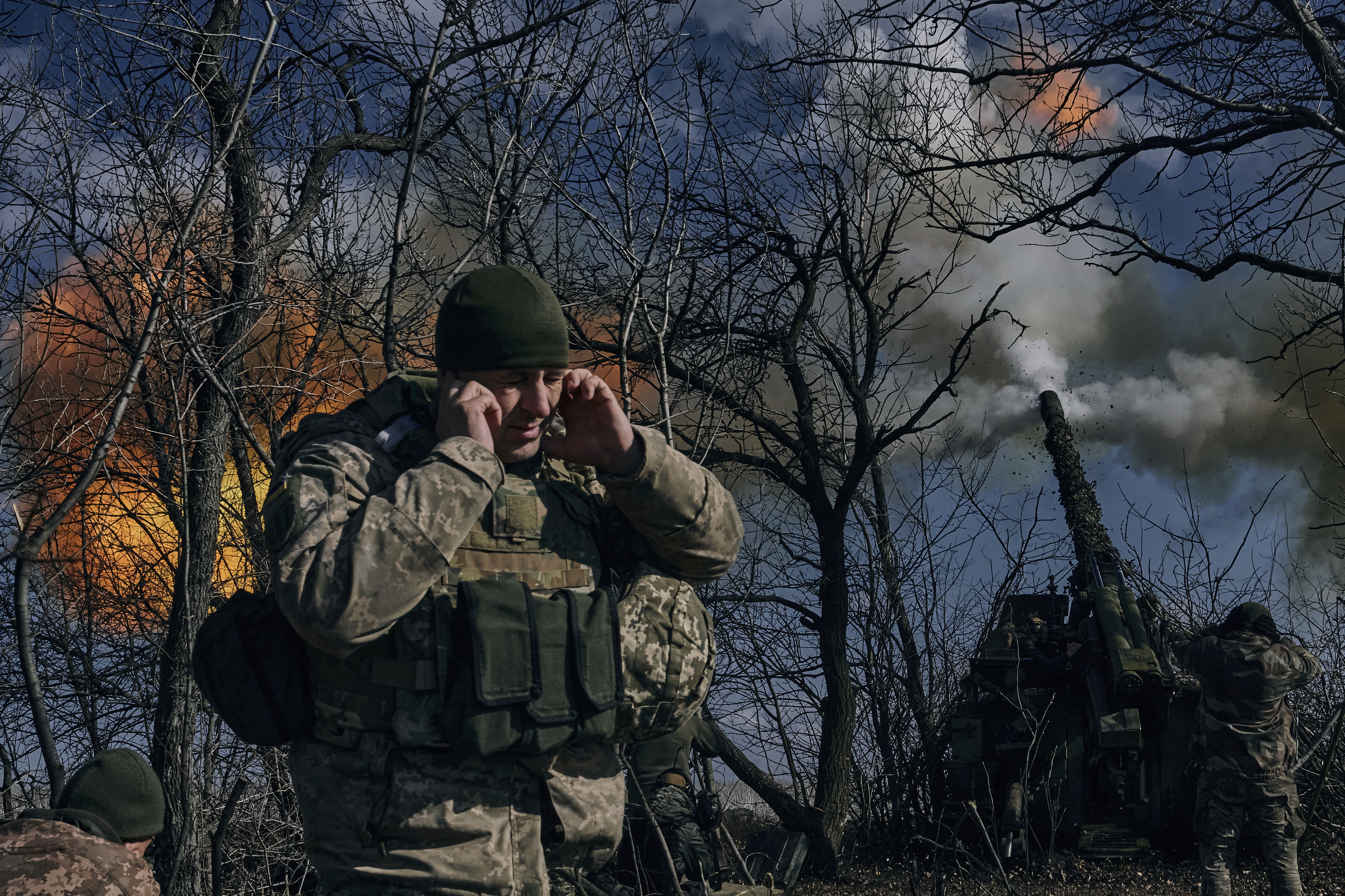 Ukrainian soldiers fire a self-propelled howitzer towards Russian positions near Bakhmut, Donetsk region