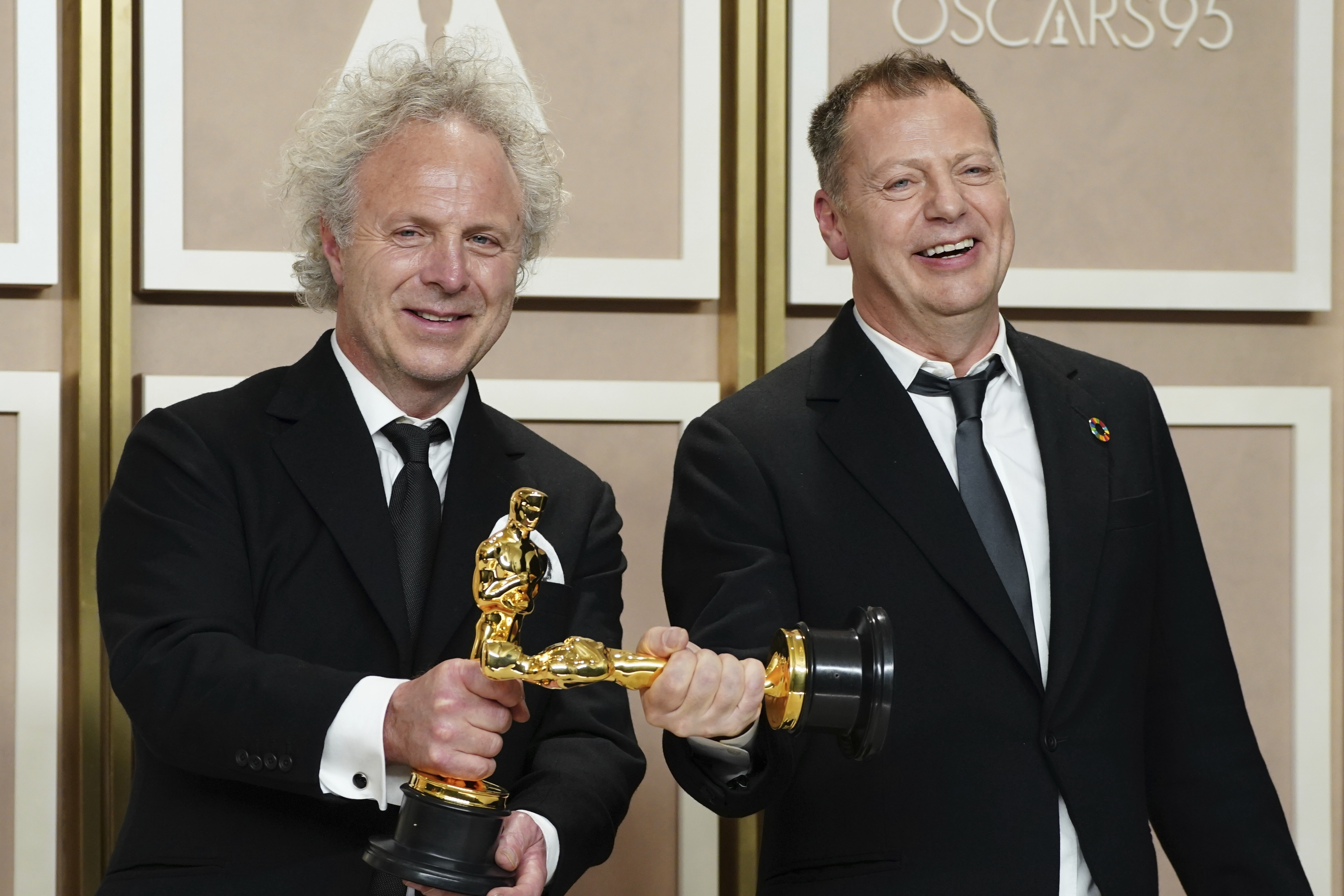 Charlie Mackesy, left, and Matthew Freud pose with the award for best animated short