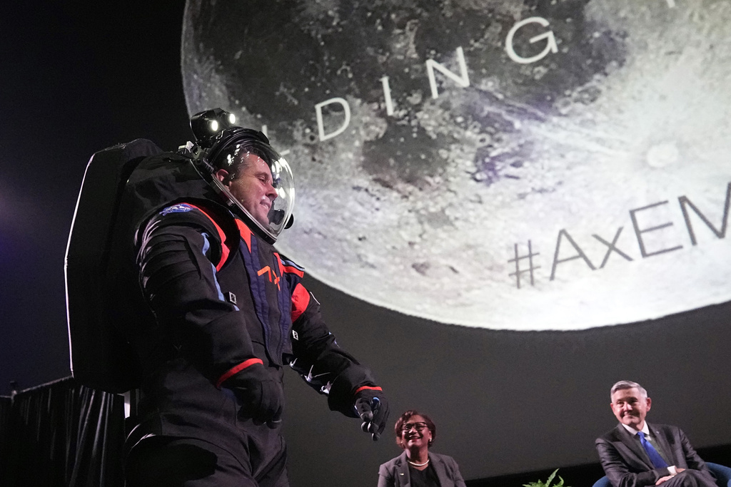 Axiom Space chief engineer Jim Stein demonstrates a prototype spacesuit, Wednesday, March 15, 2023, in Houston. NASA selected Axiom Space to design the spacesuits that its moonwalking astronauts will wear when they step onto the lunar surface later this decade. (AP Photo/David J. Phillip)