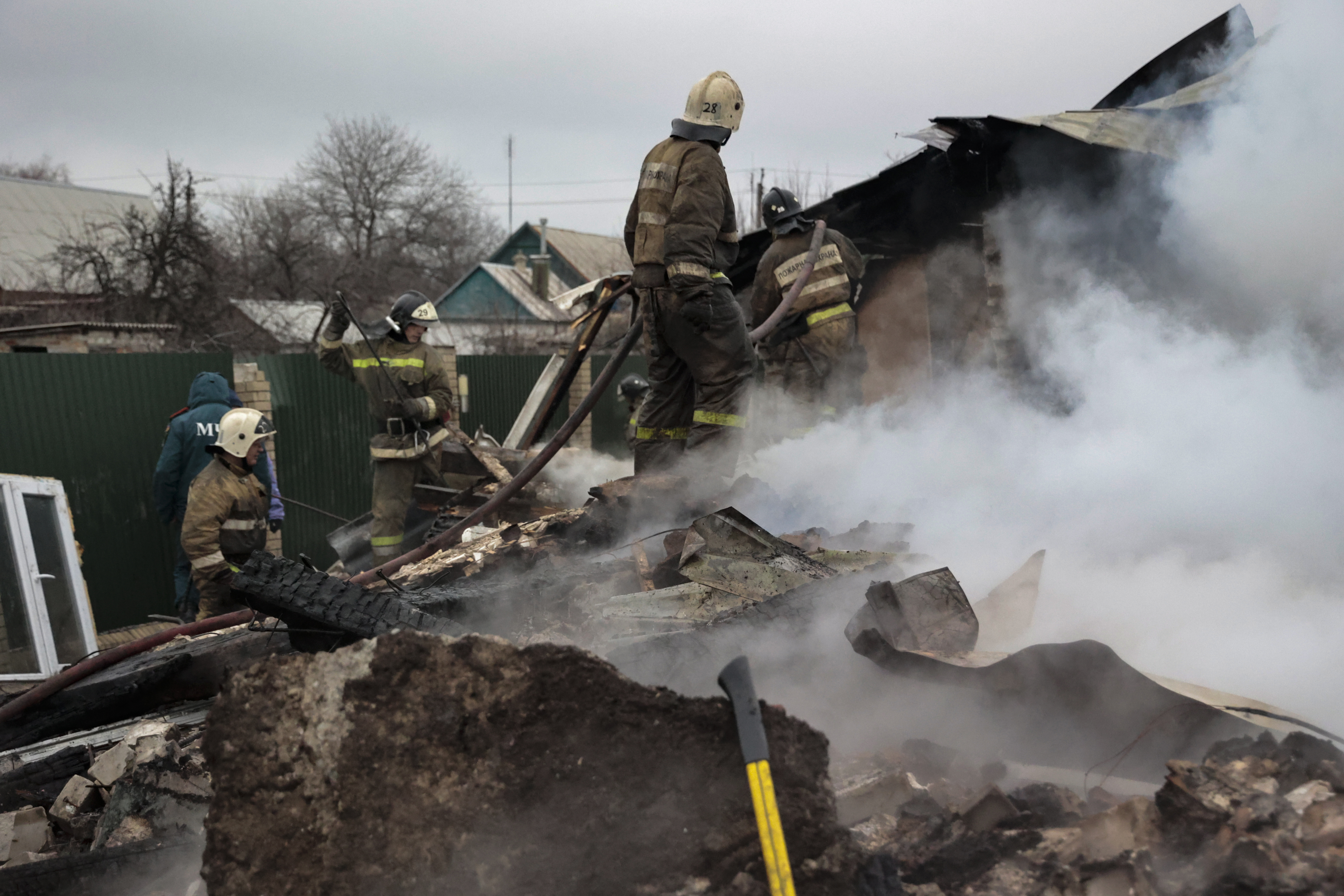 Firefighters extinguish a fire.