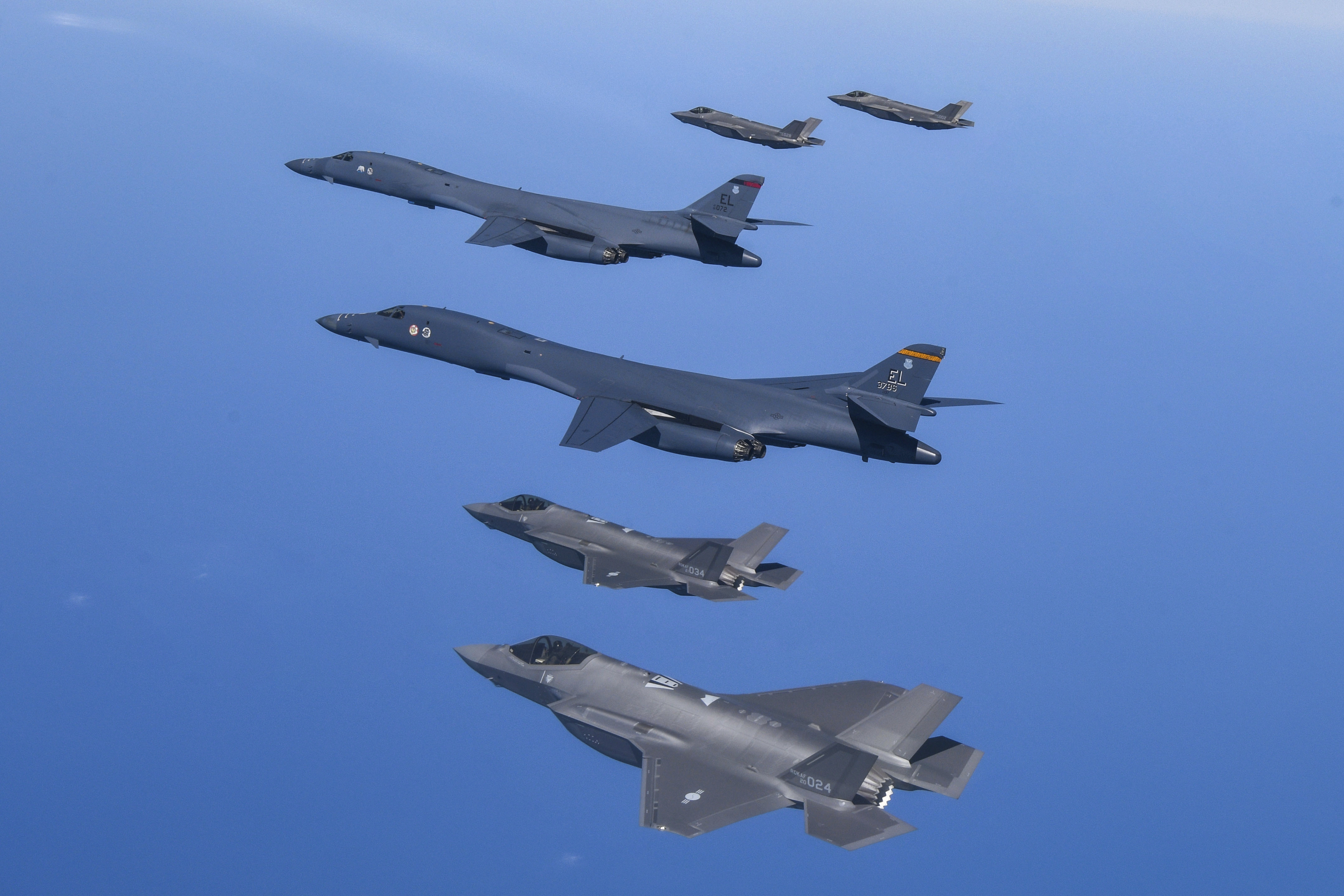 US Air Force B-1B bombers, centre, fly in formation with South Korea’s Air Force F-35A fighter jets over the South Korean Peninsula during a joint air drill in South Korea in March 2023