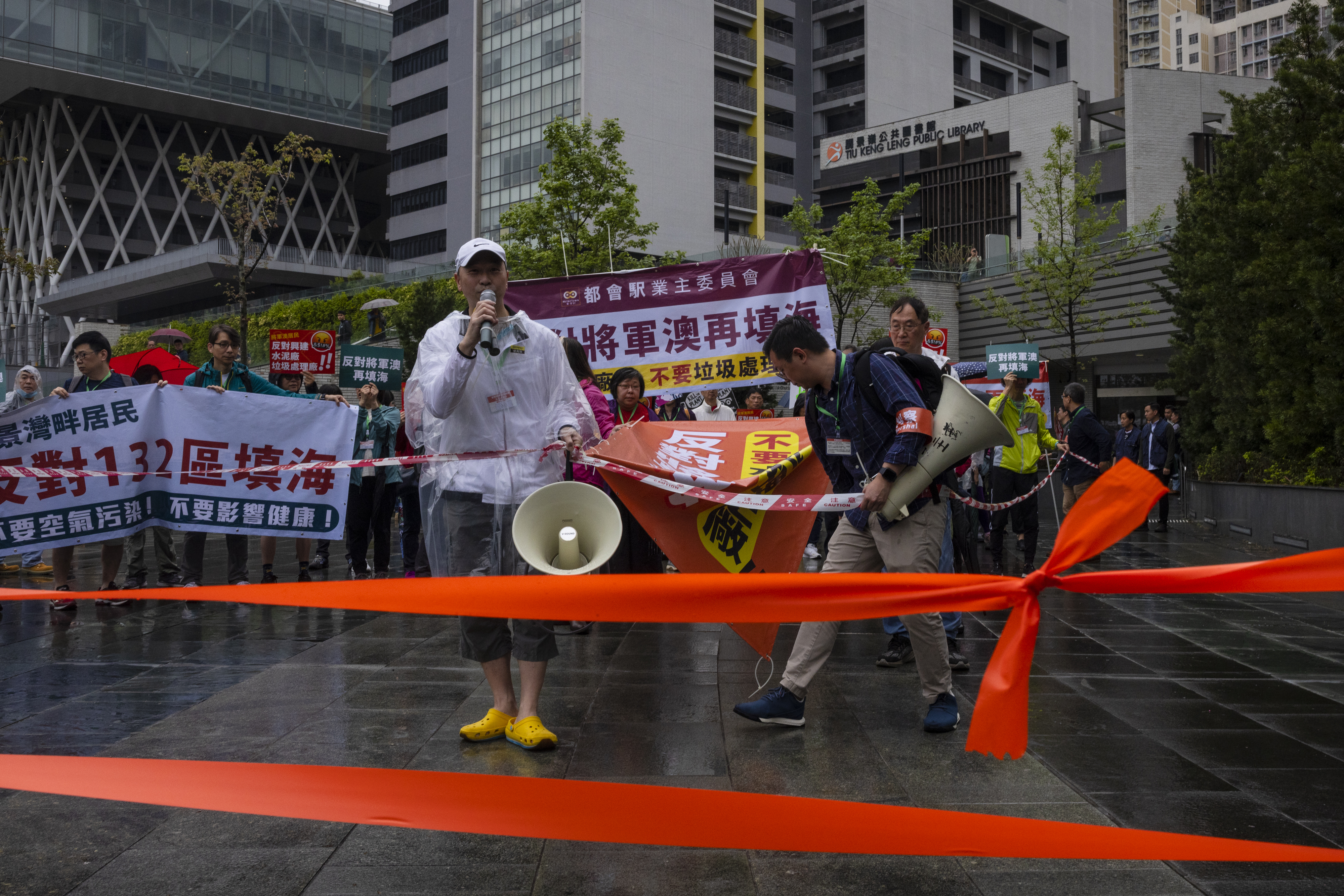 Dozens of people joined Hong Kong’s first demonstration against the government to be authorised since the lifting of major COVID restrictions under unprecedentedly strict rules