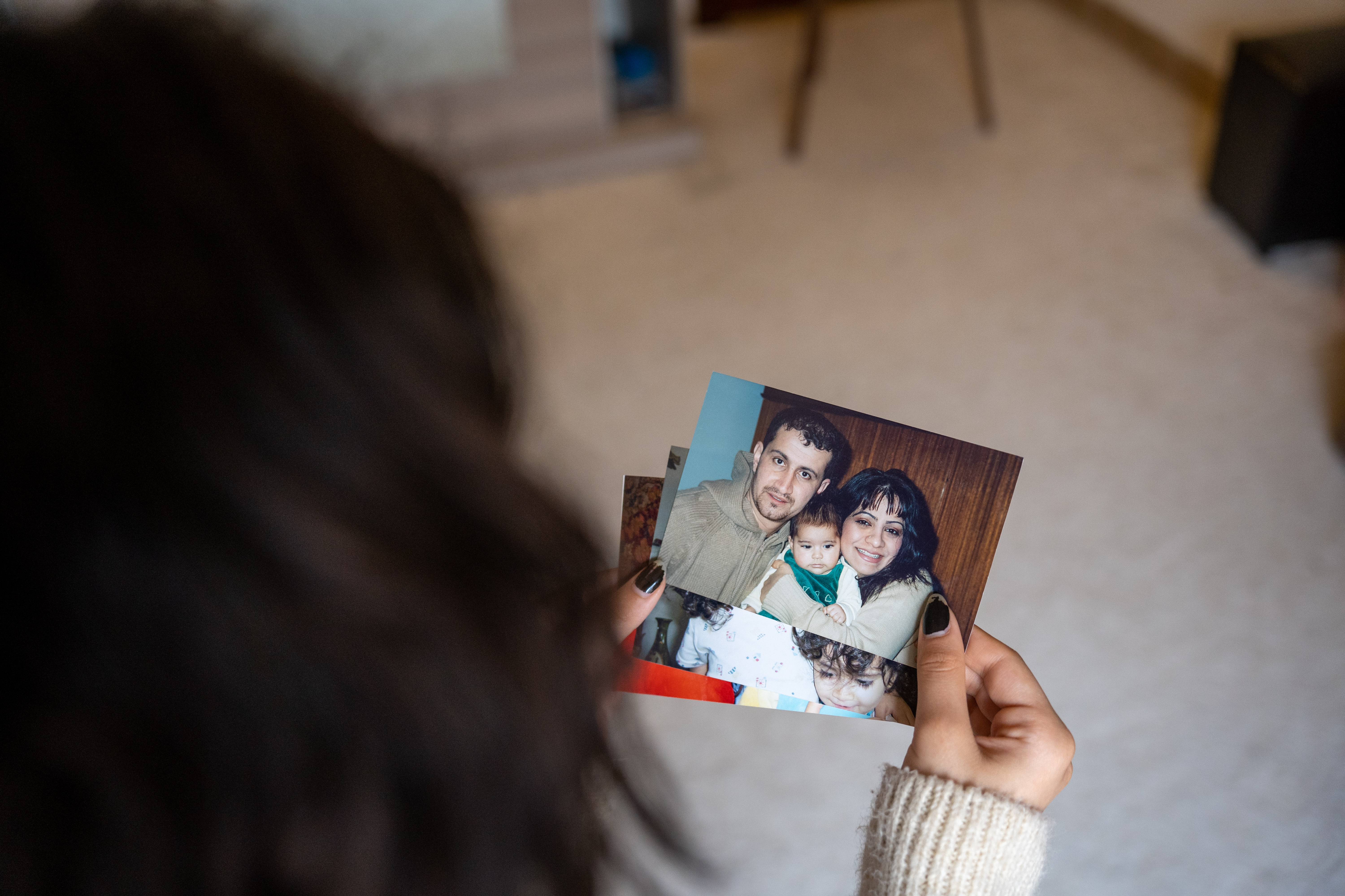 Sham holding an old photo showing her with her parents