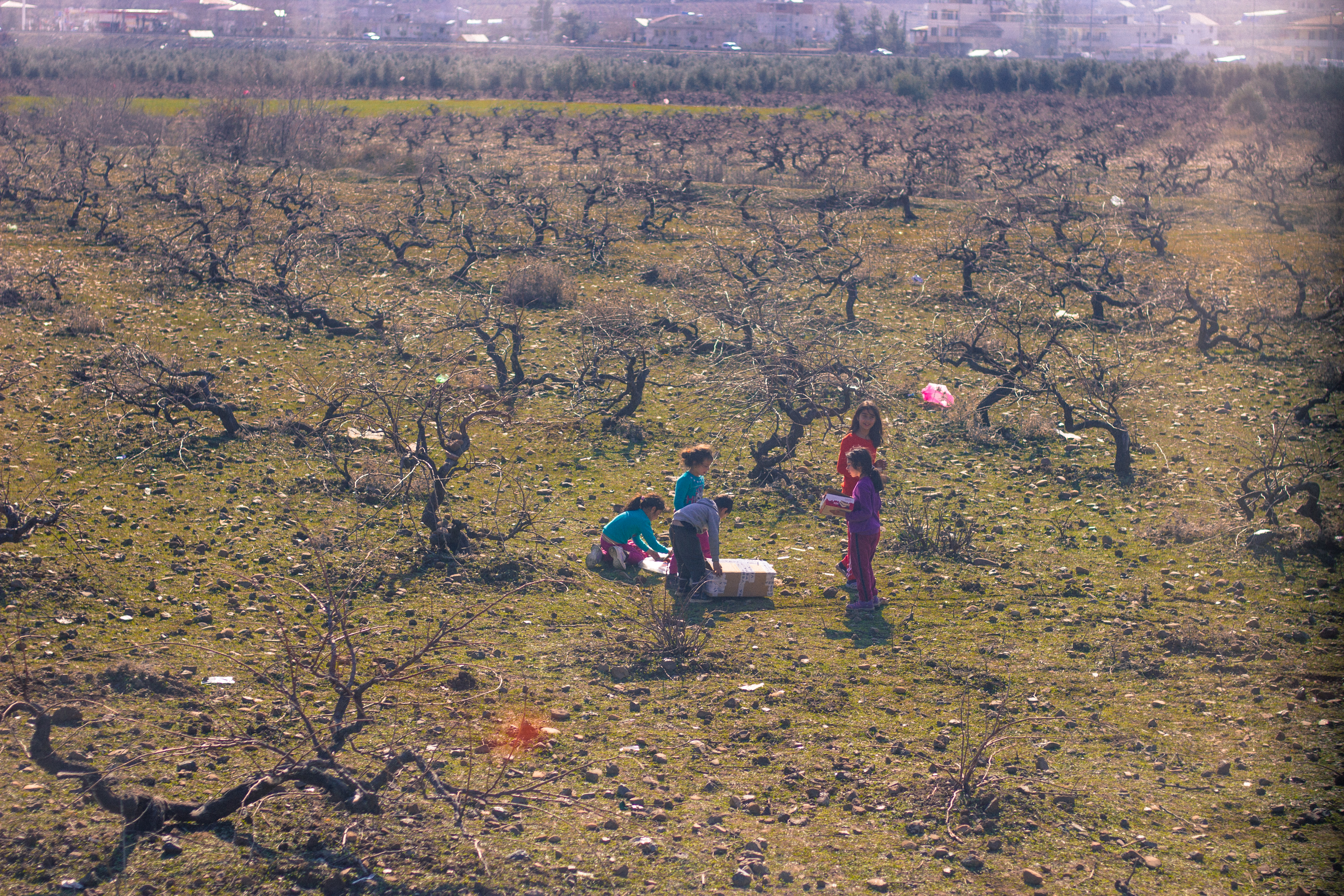 Girls play with the discarded packaging of emergency aid in Islahiye, Gaziantep