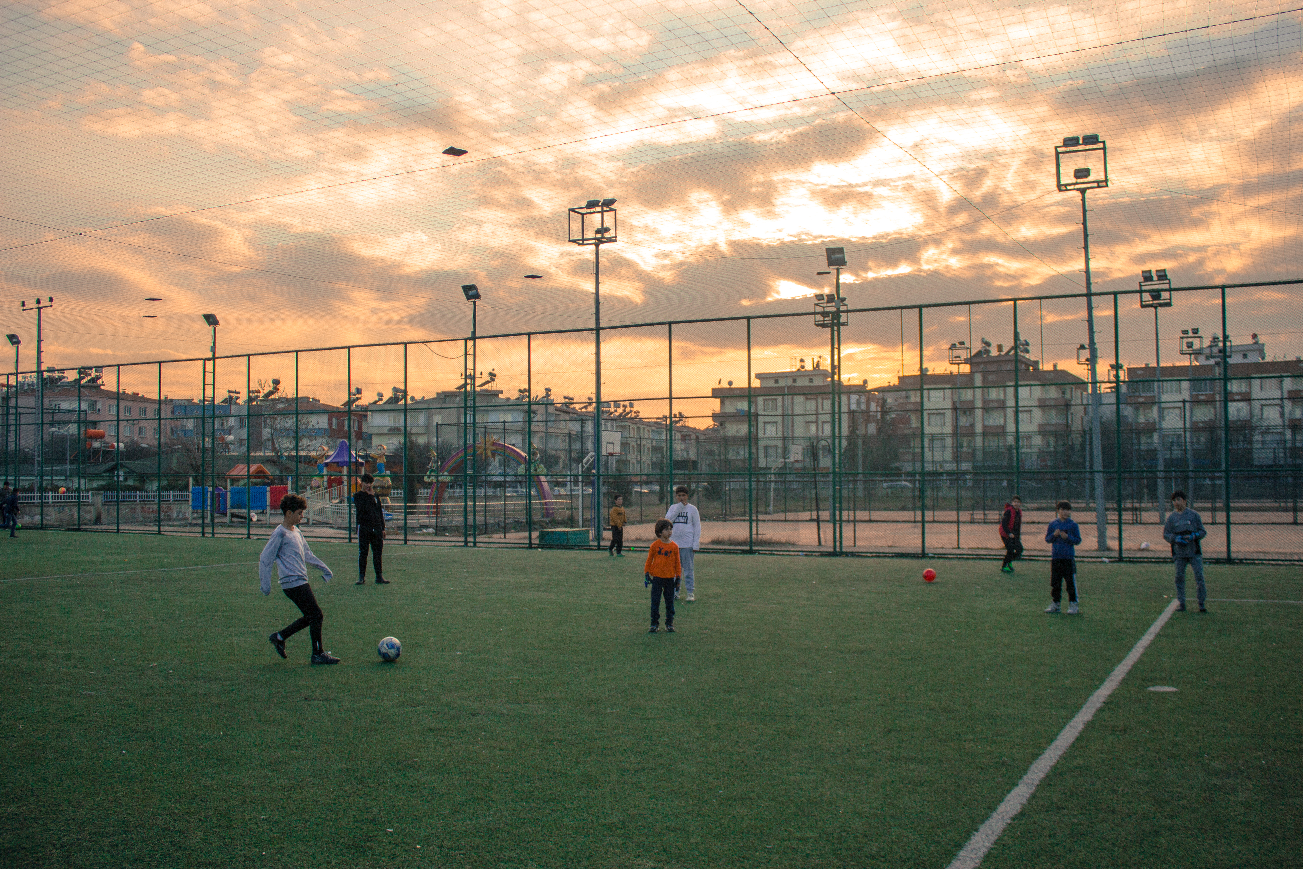 Syrian refugees kids in the Gazikent shelter keep playing football, which allows them to bond