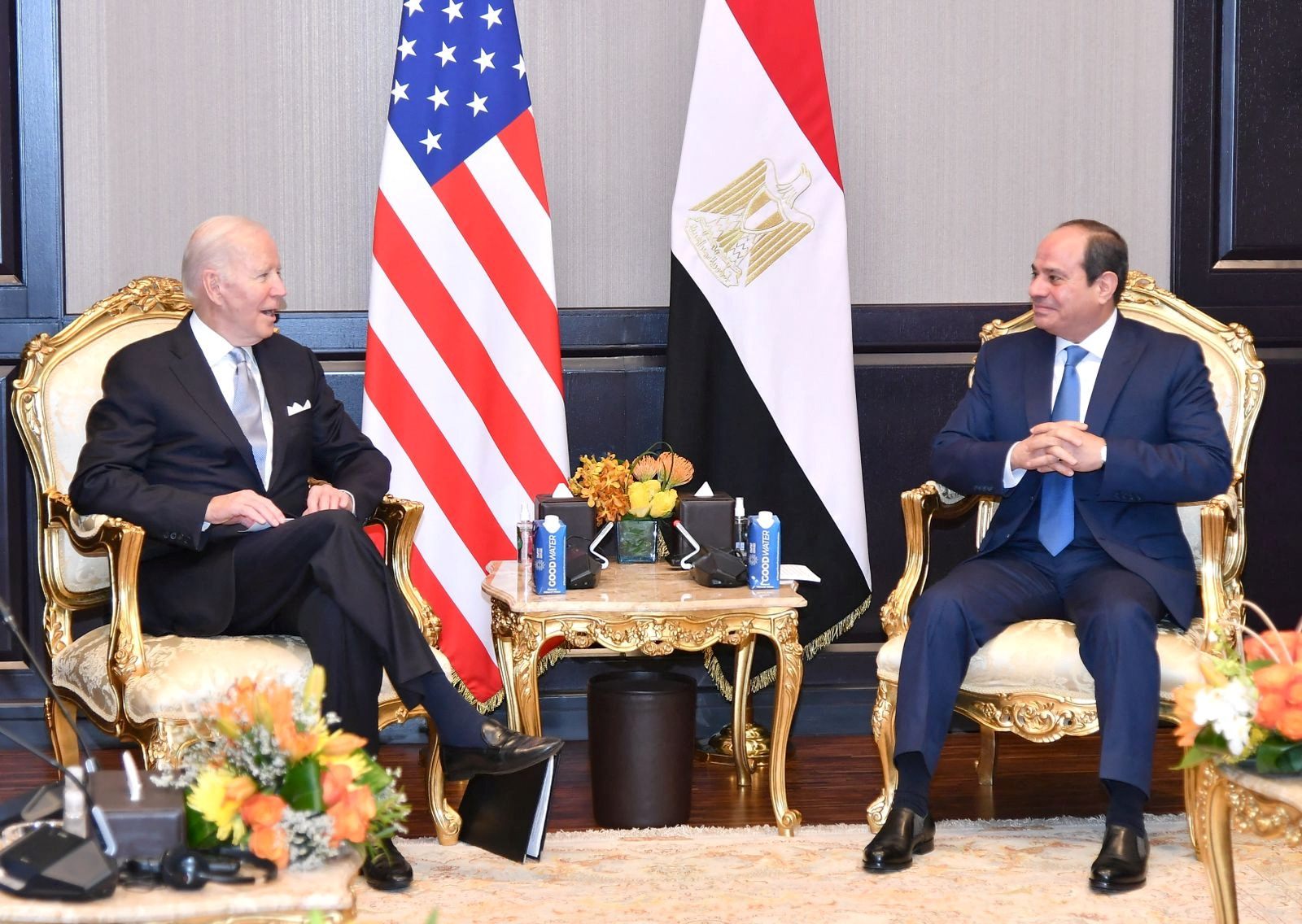 Joe Biden sits across from Abdel Fattah el-Sisi with American and Egyptian flags in the background