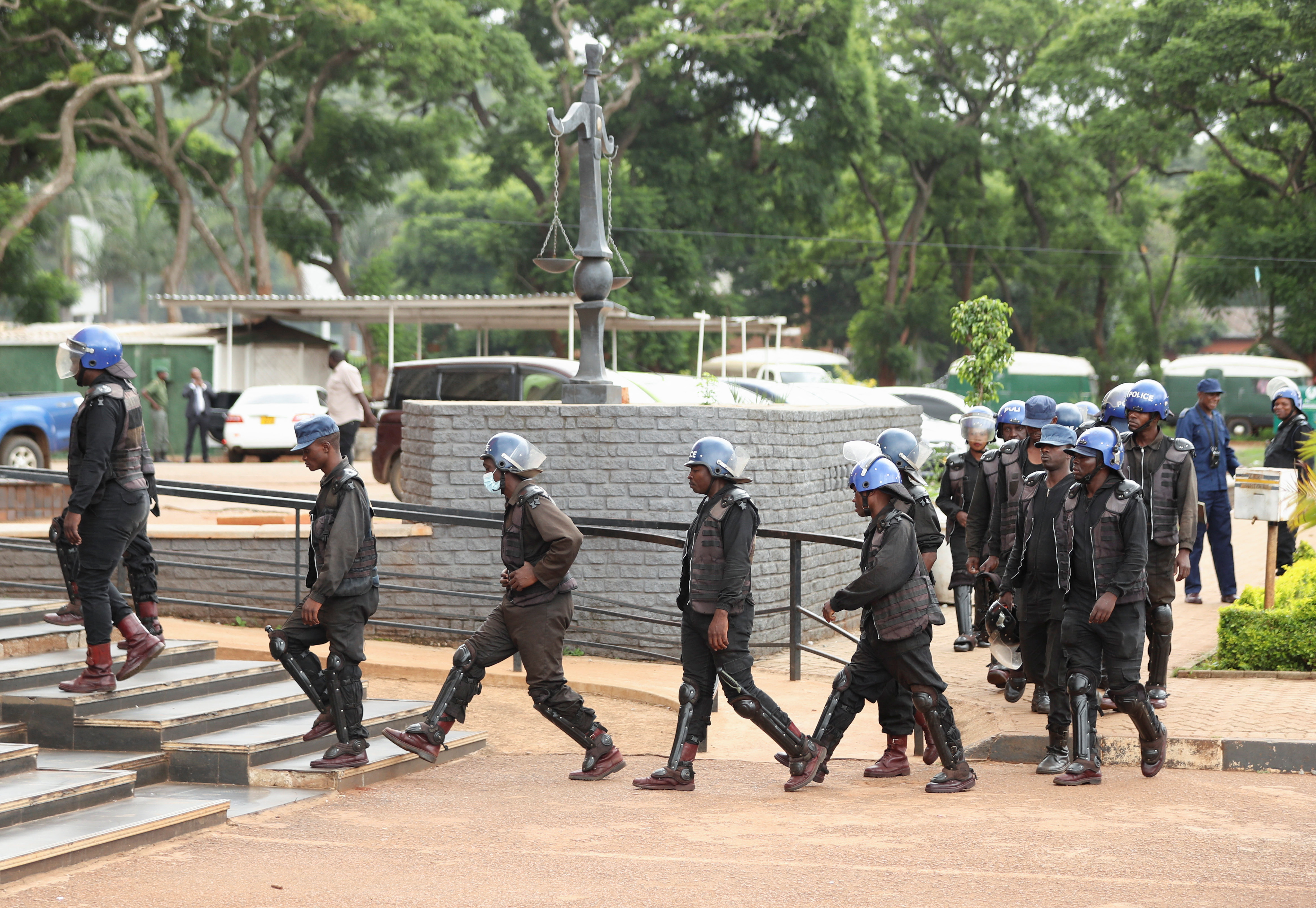 Anti-riot police arrives at the magistrate court where 25 opposition party Citizens Coalition for Change supporters appear for a bail hearing after they were arrested for unlawful gathering with intent to incite public violence in Harare, Zimbabwe, January 16, 2023. [Philimon Bulawayo/Reuters]