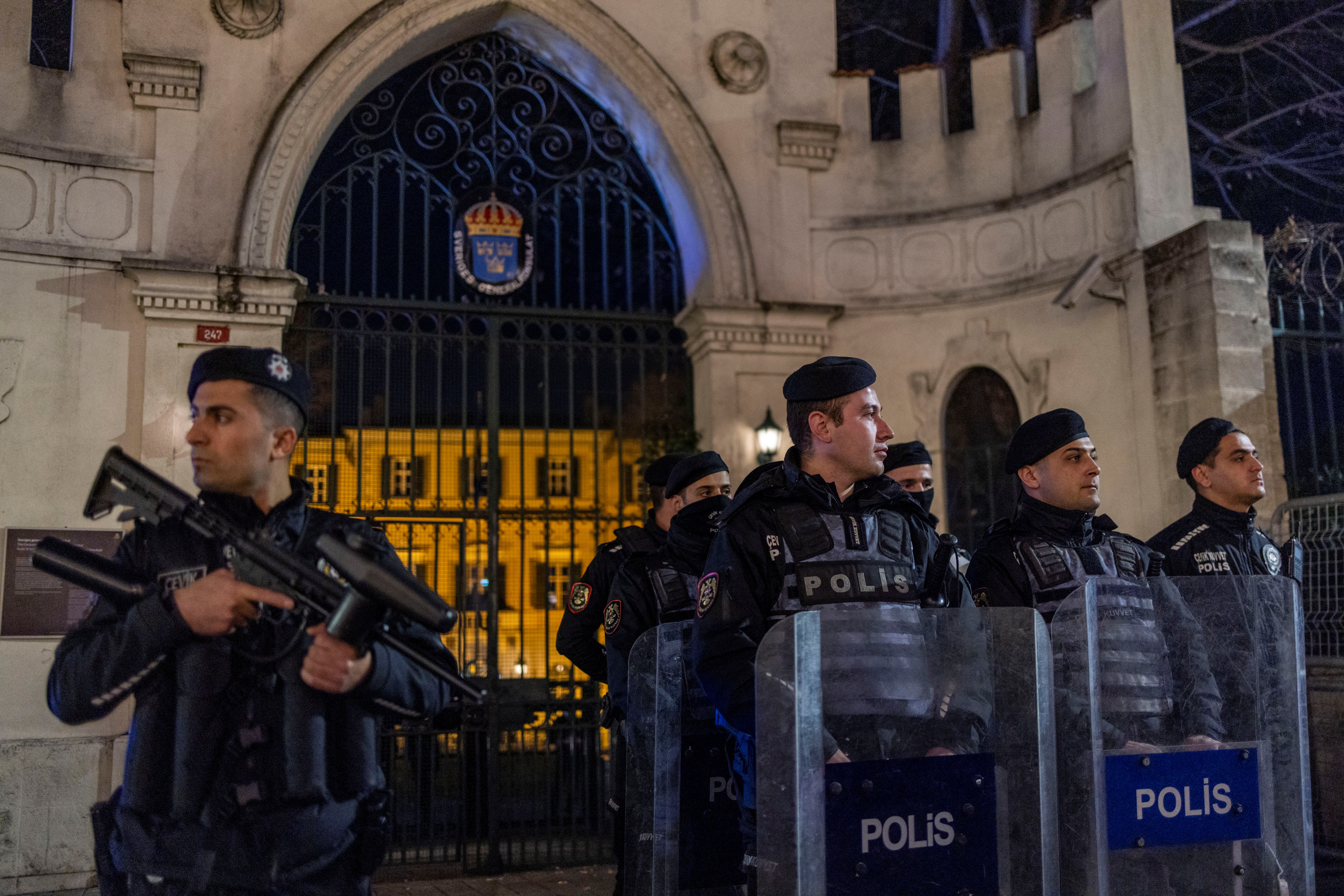 Riot police officers secure the entrance of the Consulate General of Sweden during a demonstration, after Rasmus Paludan, leader of Danish far-right political party Hard Line and who also has Swedish citizenship burned a copy of the Koran near the Turkish Embassy in Stockholm, in Istanbul, Turkey, January 21, 2023. REUTERS/Umit Bektas