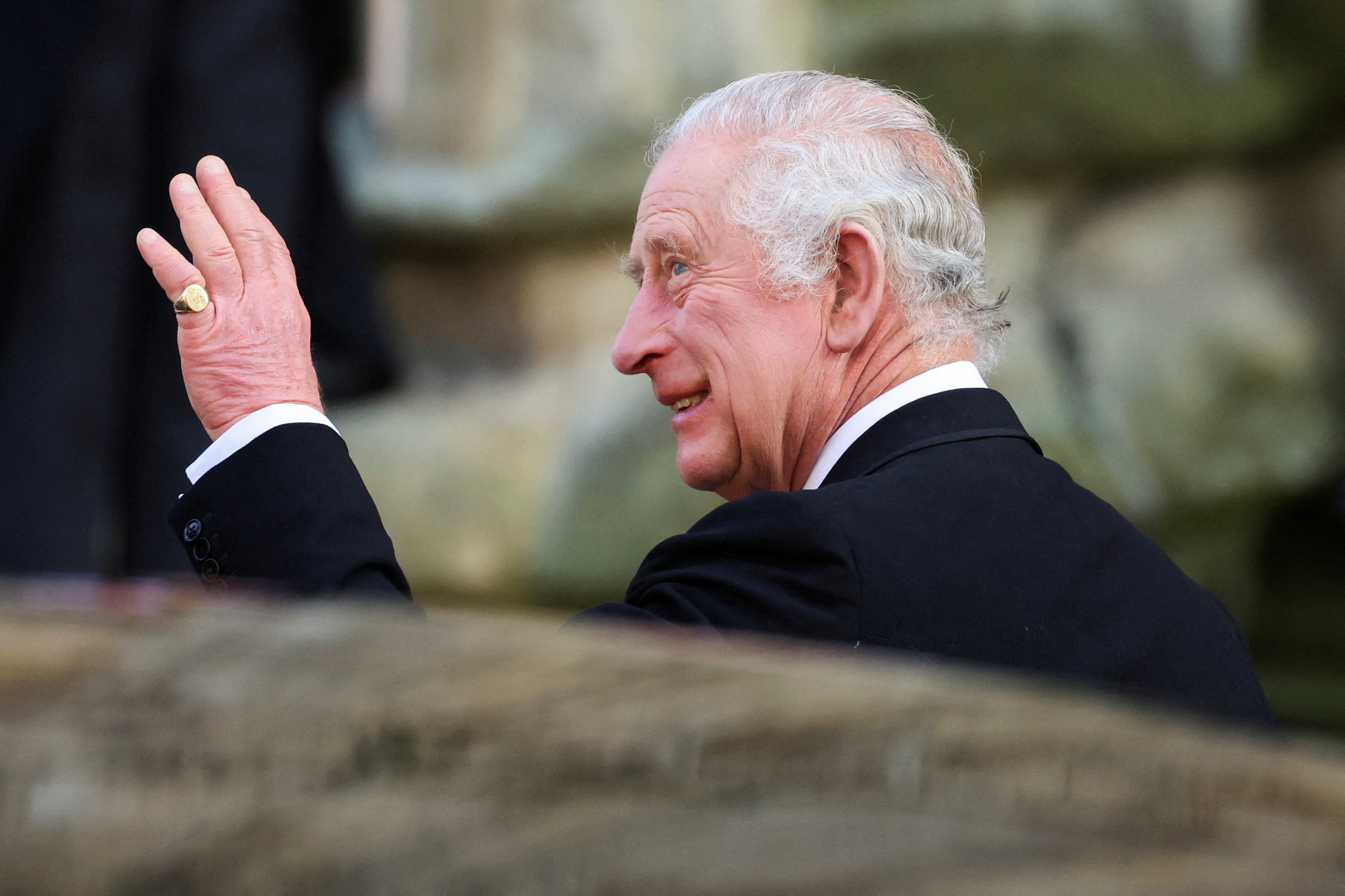 King Charles III waves