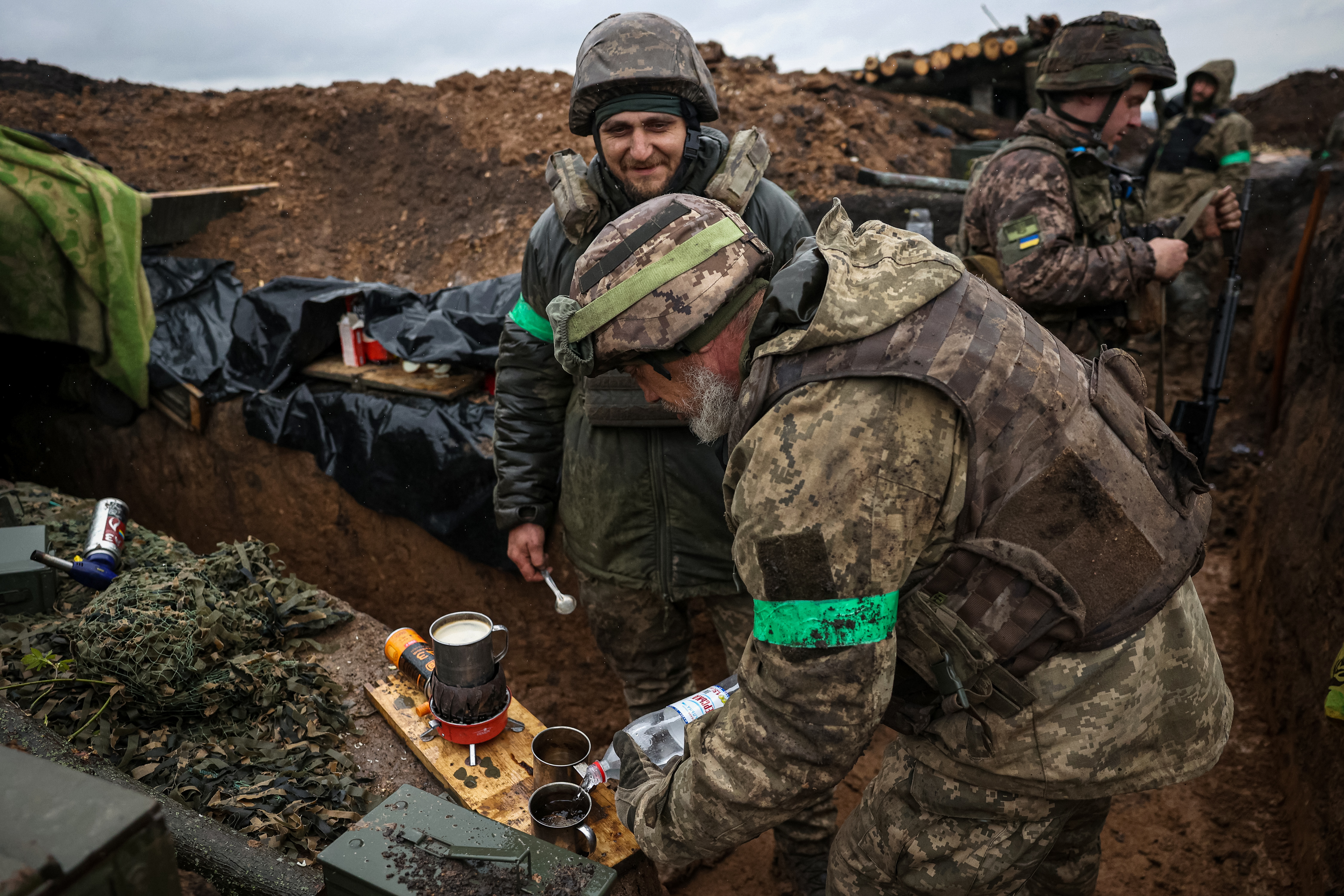Ukrainian infantrymen of the 57th Separate Motorized Infantry Brigade "Otaman Kost Khordienko" makes a coffee in a trench at an undisclosed location near the town of Bakhmut, Donetsk region, eastern Ukraine on April 13, 2023, amid the Russian invasion of Ukraine.