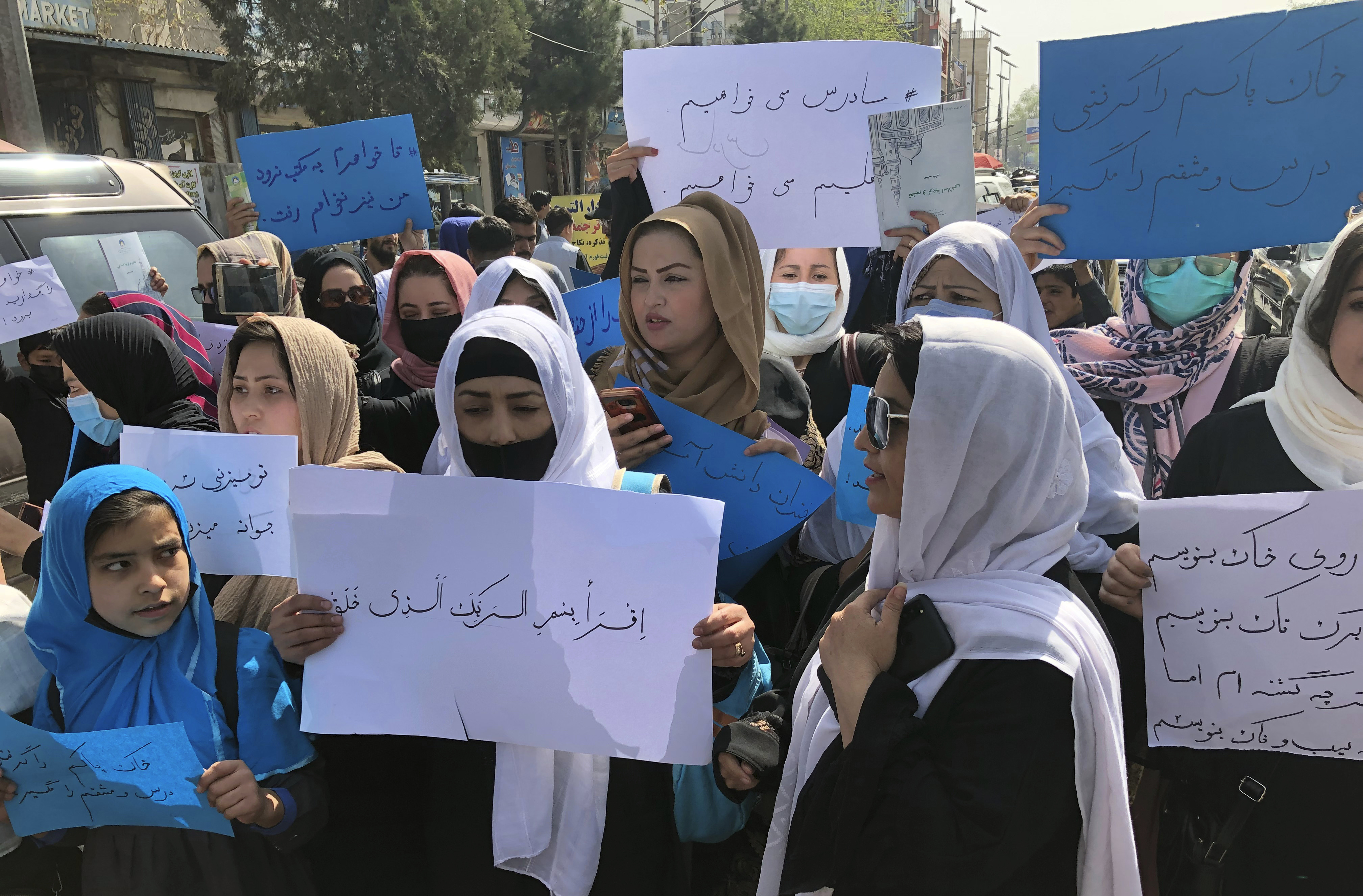 Afghan women chant and hold signs of protest during a demonstration in Kabul, Afghanistan, March 26, 2022