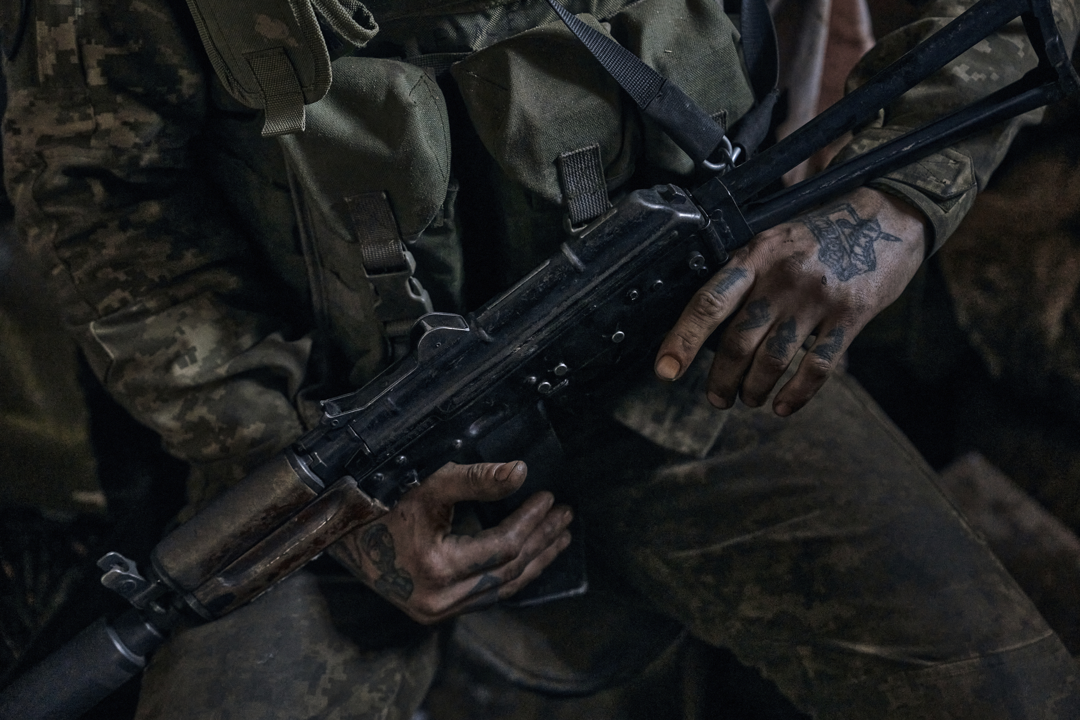 A Ukrainian soldier holds a gun as he takes a short rest on the front line in the Donetsk region, Ukraine, Monday, April 24, 2023.