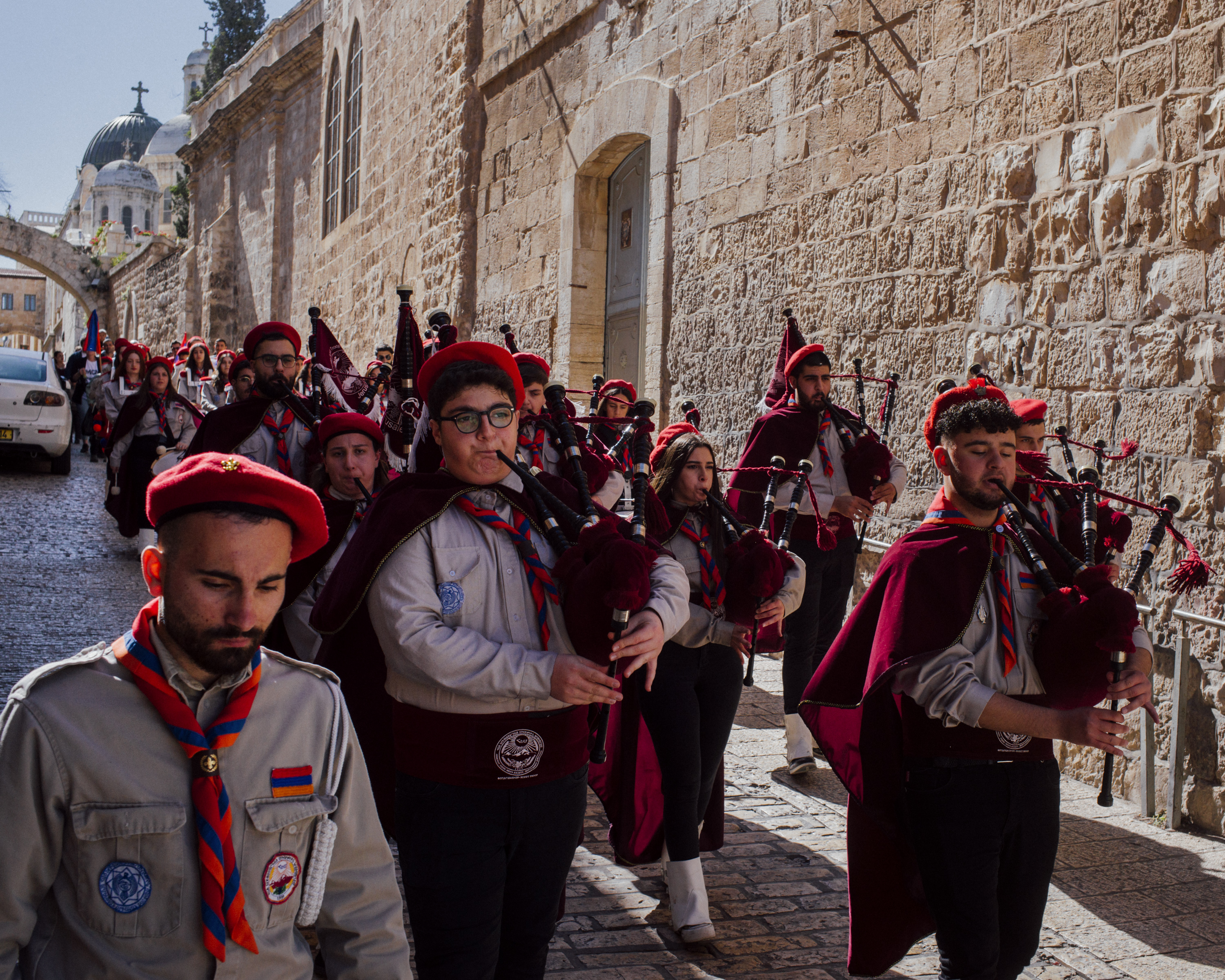 The Armenian scouts march through the Old City of Jerusalem on Palm Sunday, April 2, 2023. Scout leader Hagop Djernazian appears on the left