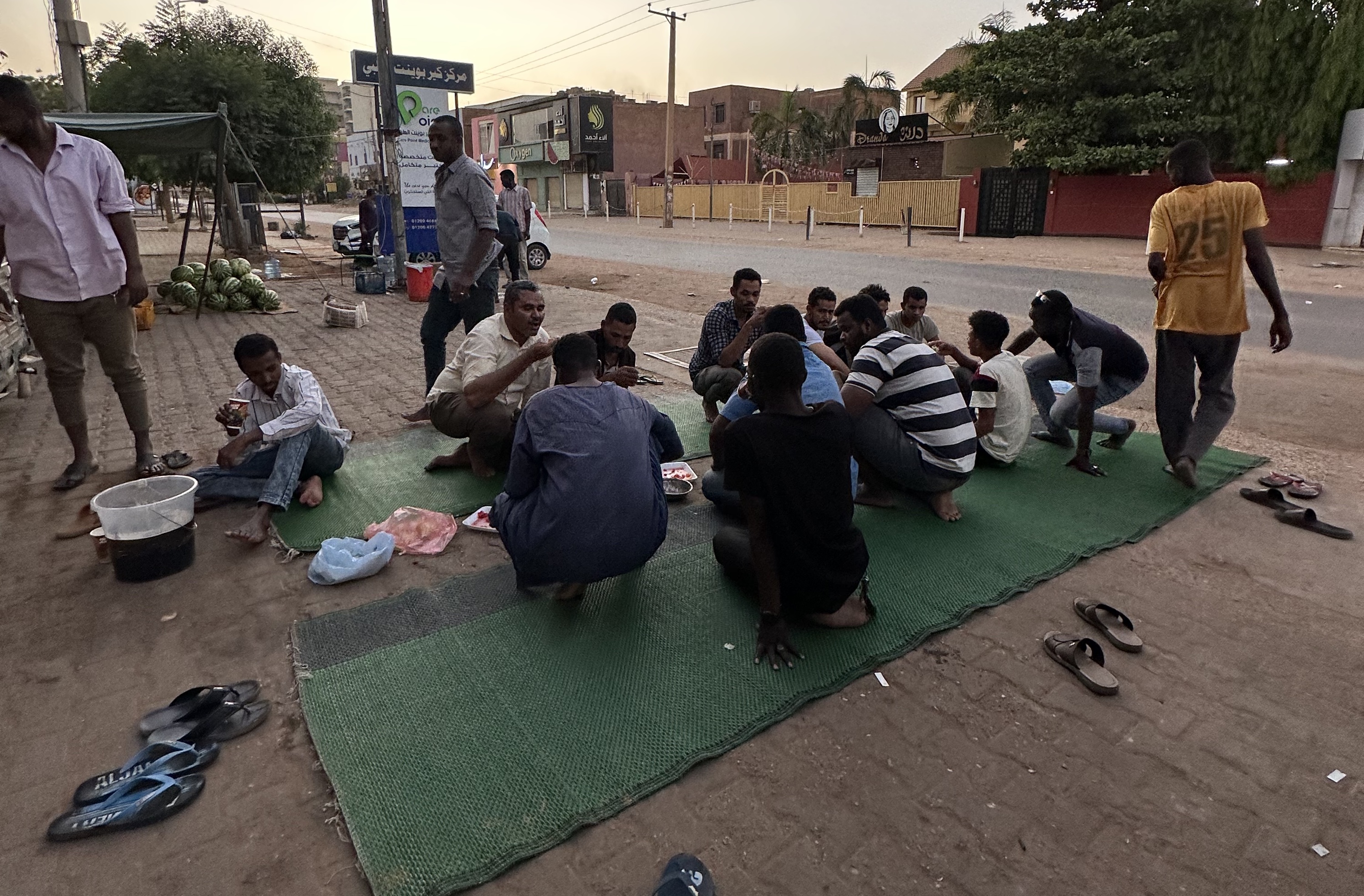 Sudanese men break their Ramadan fast together on the streets of Khartoum