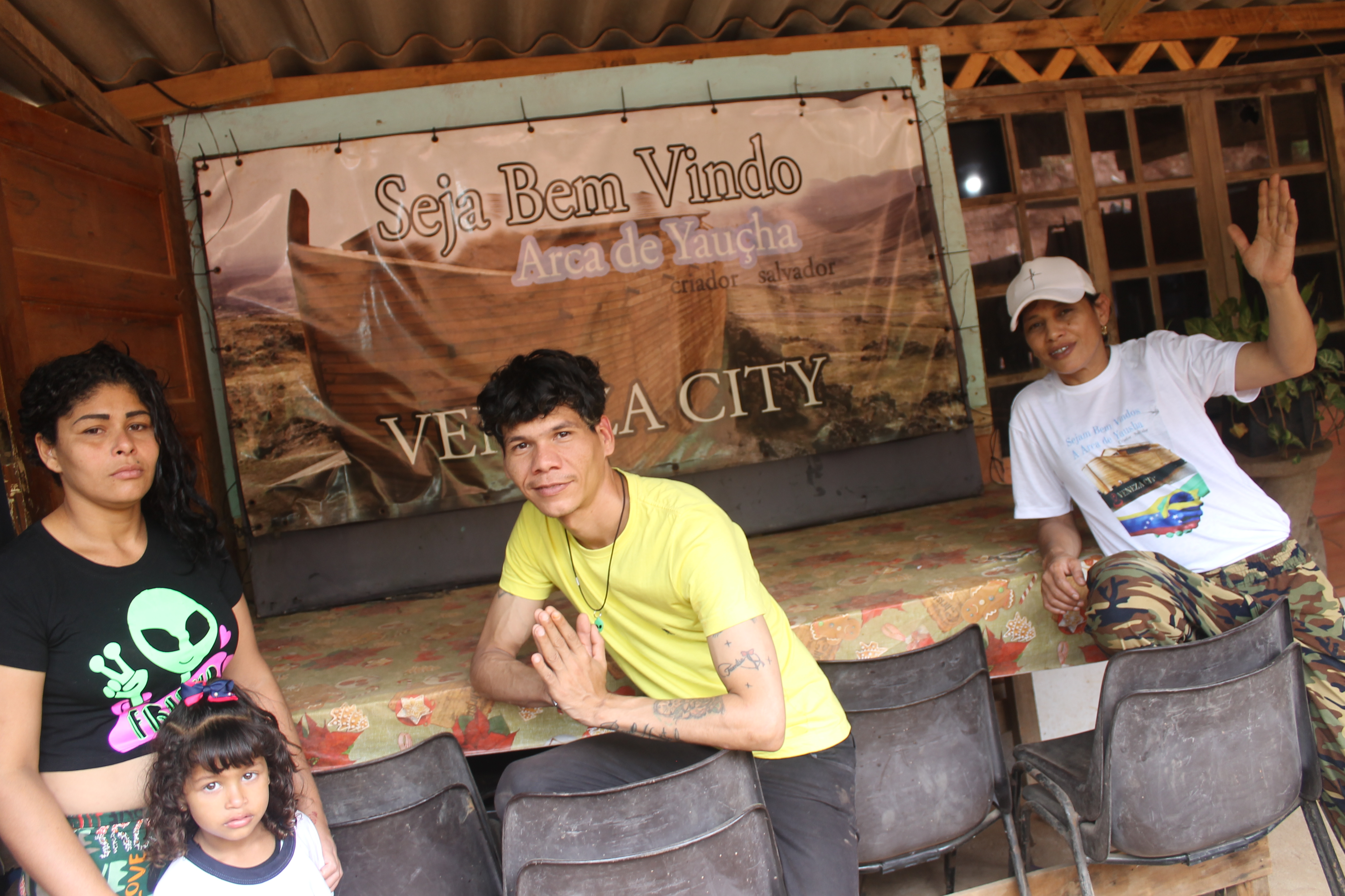 Residents Marioxy Palma (left) and Leonardo (centre) pose for a photo with community leader Debora Maria dos Santos