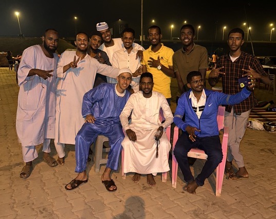 Ahmed El-Badawy with Sudanese men he met during his travels around Khartoum