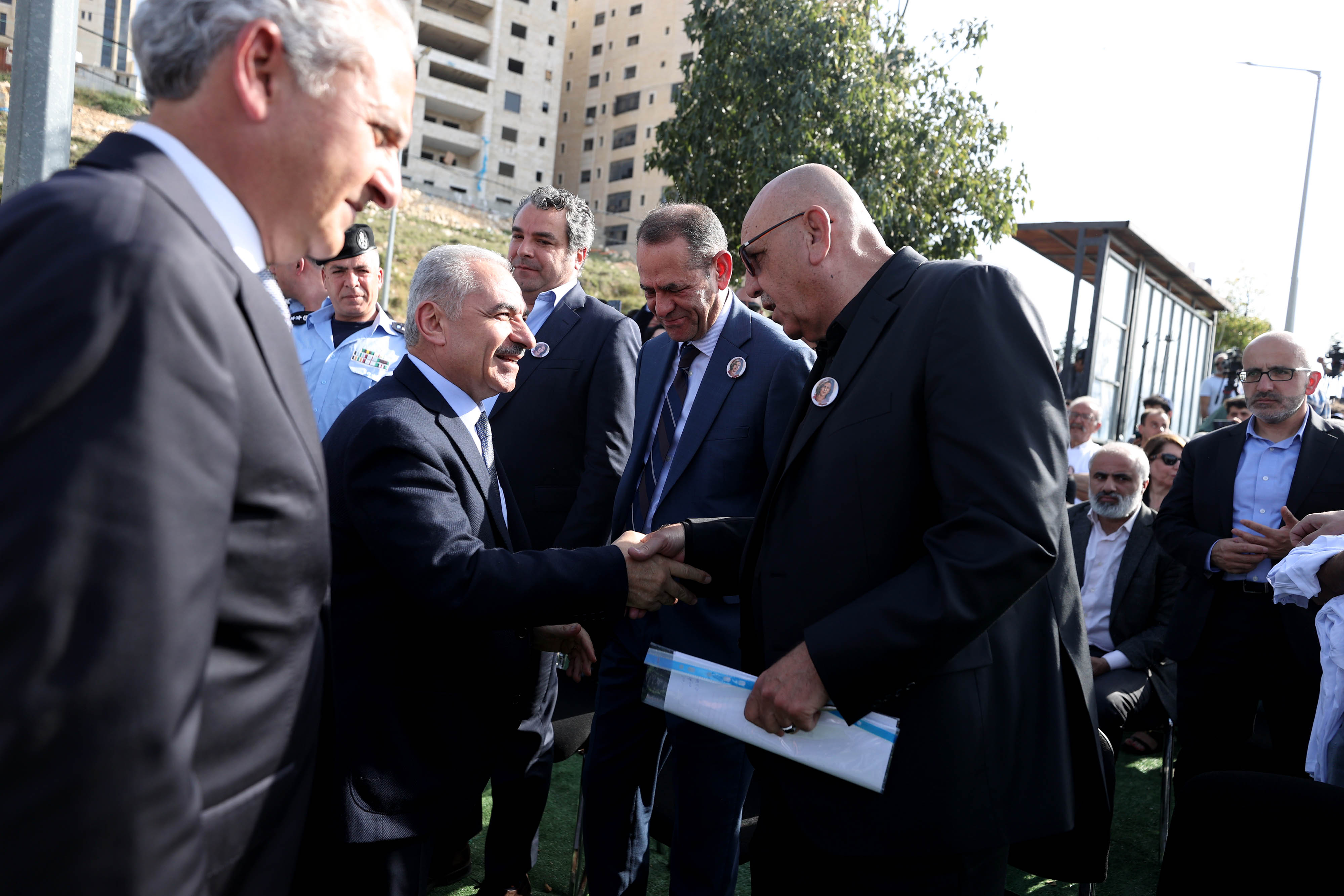 PA Prime Minister Shtayyeh greets Al Jazeera Palestine bureau chief Walid al-Omari and Abu Akleh’s brother, Anton [Al Jazeera]