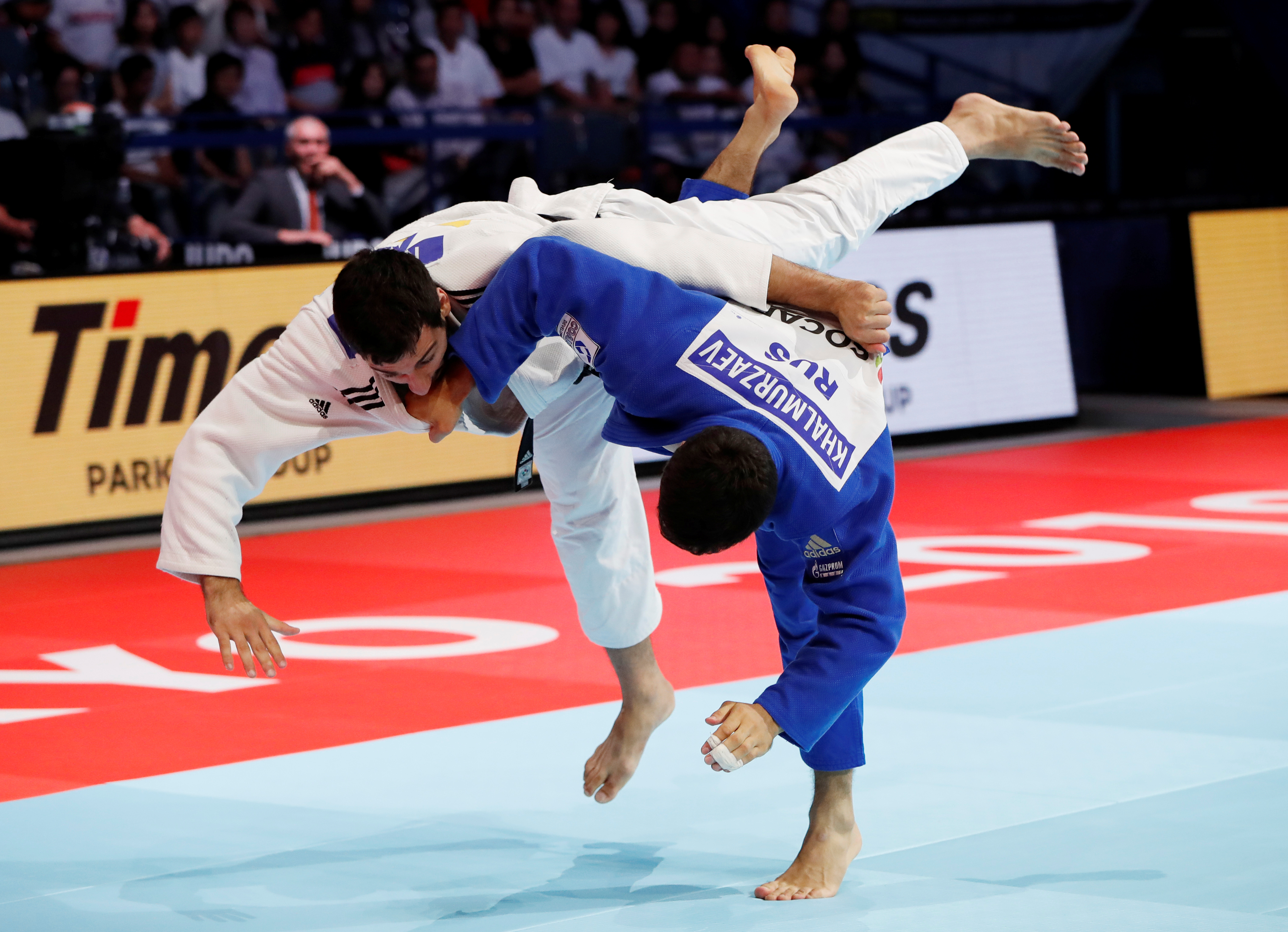 Azerbaijan's Mammadali Mehdiyev and Russia's Khusen Khalmurzaev fly through the air as they compete in the Tokyo judo world championships