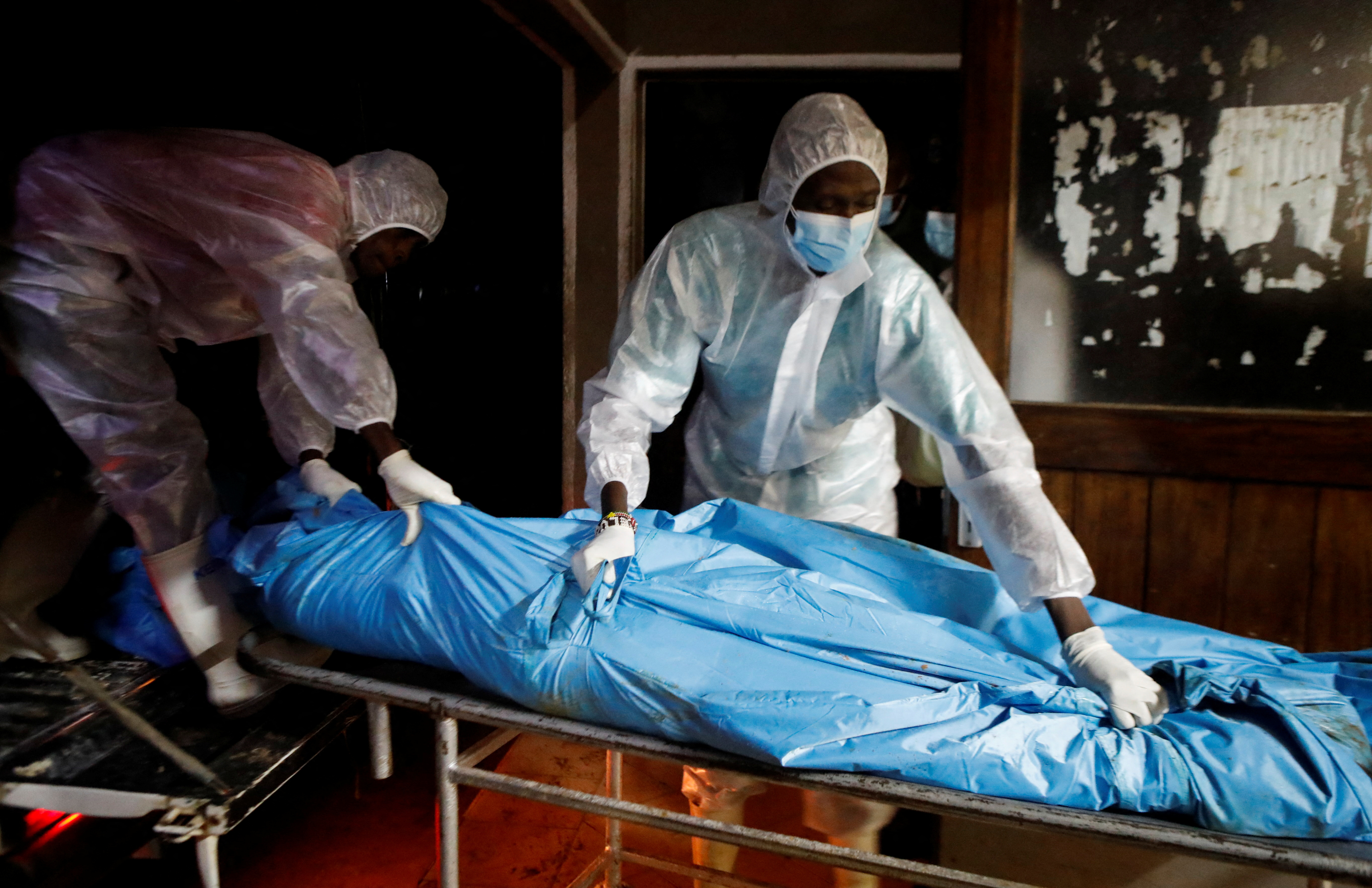 Workers receive the exhumed bodies of followers of a Christian cult named Good News International Church