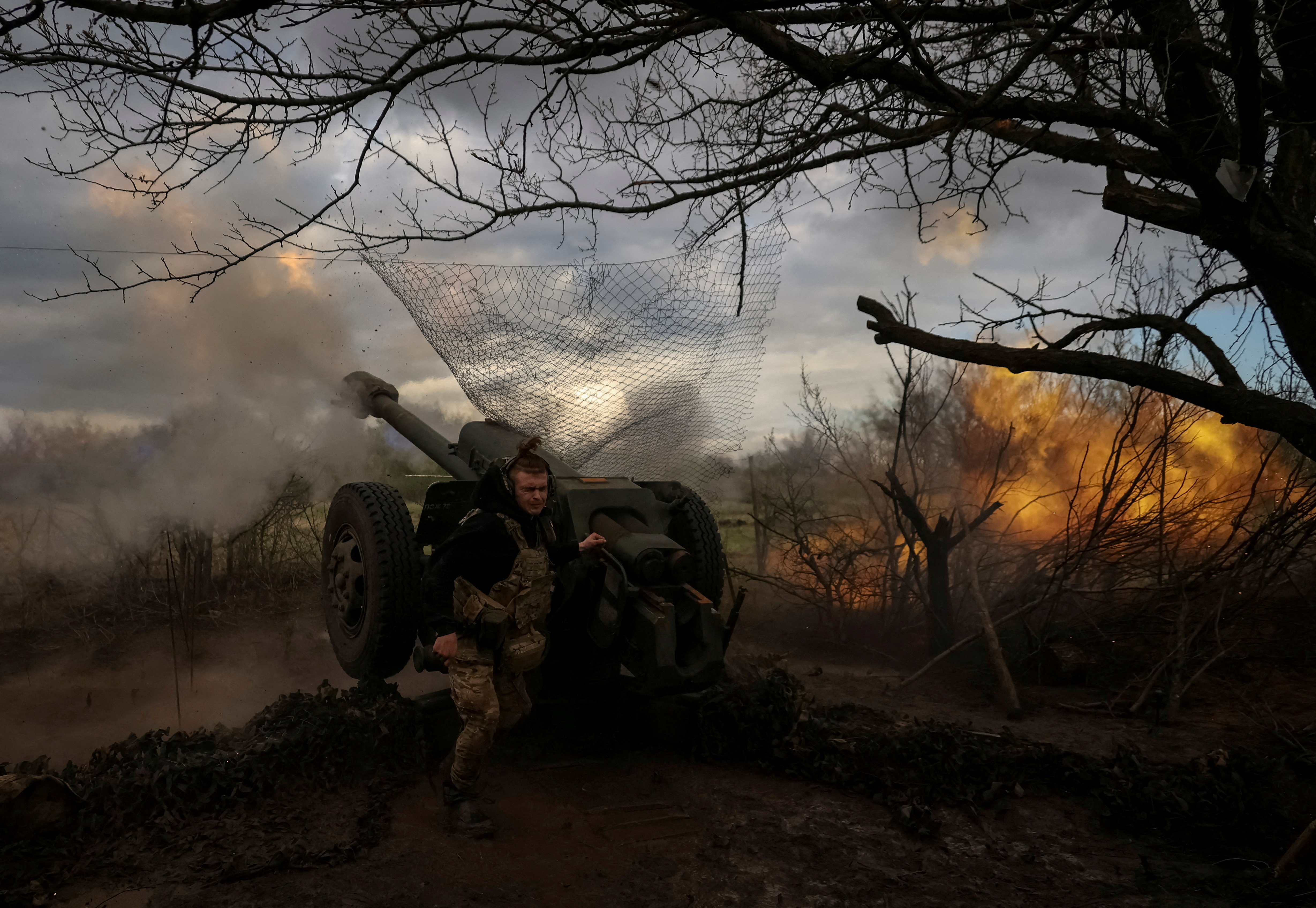 Ukrainian service members from a 3rd separate assault brigade of the Armed Forces of Ukraine, fire a howitzer D30 at a front line, amid Russia's attack on Ukraine, near the city of Bakhmut