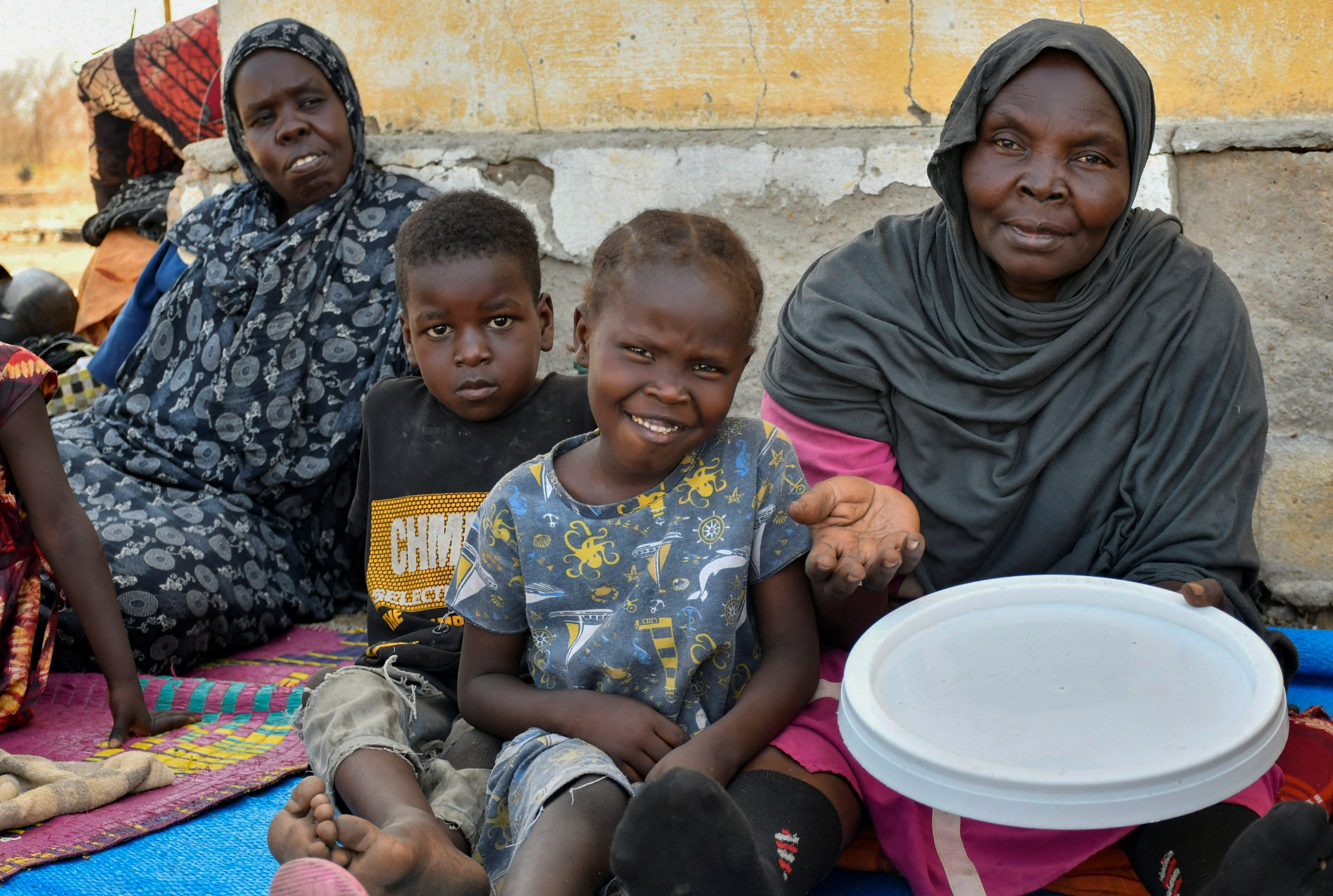 Women and their children who fled Sudan following the outbreak of fighting between the Sudanese army and the RSF, sit at the UN High Commissioner for Refugees (UNHCR) transit centre in Renk, South Sudan May 1, 2023