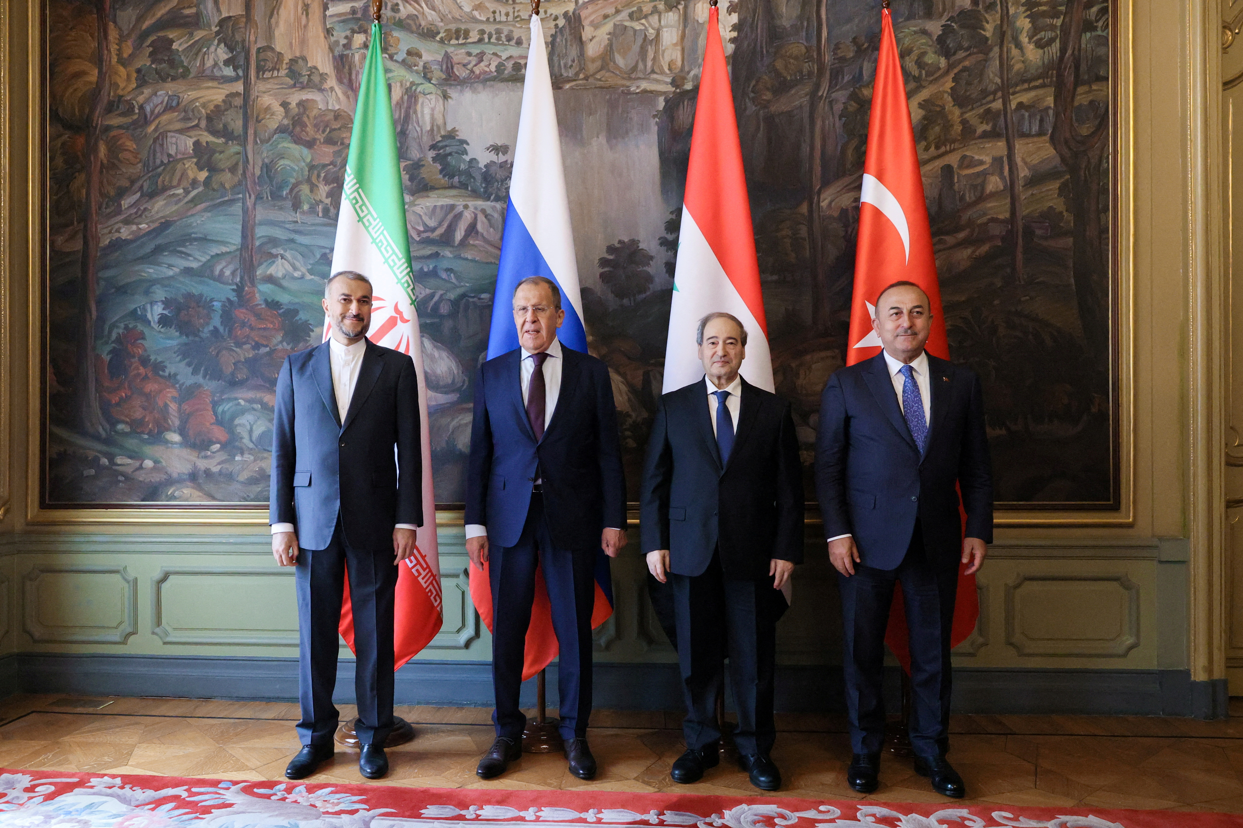 Foreign ministers Hossein Amirabdollahian of Iran, Sergei Lavrov of Russia, Faisal Mekdad of Syria and Mevlut Cavusoglu of Turkey pose for a picture during a meeting in Moscow
