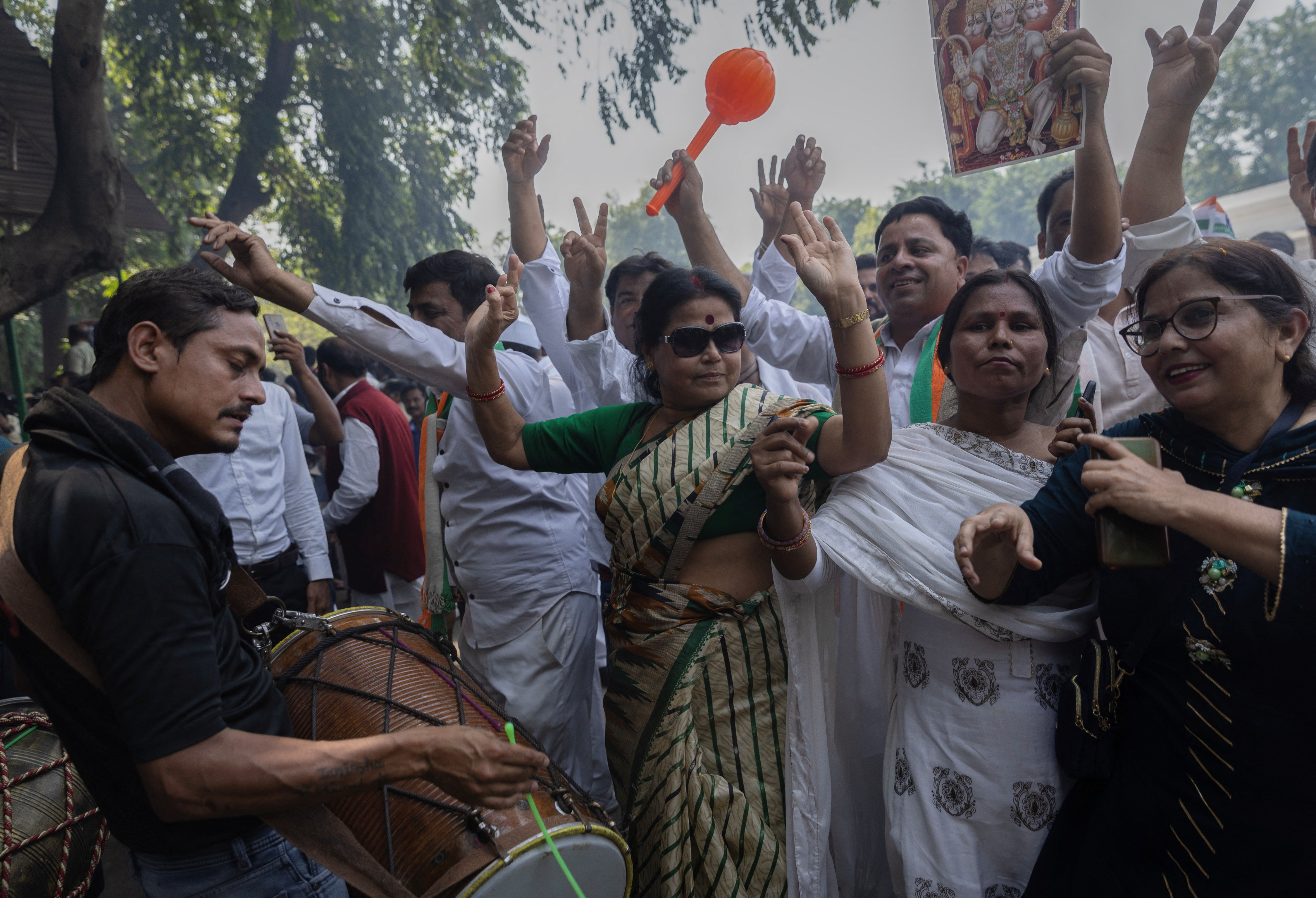 Supporters of India's main opposition Congress party celebrate after the initial poll results in Karnataka elections at the party headquarters, in New Delhi,