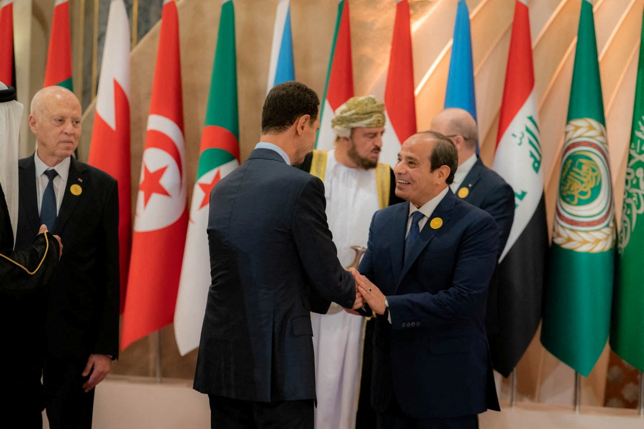 Syria’s President Bashar al-Assad shakes hands with Egypt’s President Abdel Fattah al-Sisi ahead of the Arab League summit in Jeddah on May 19
