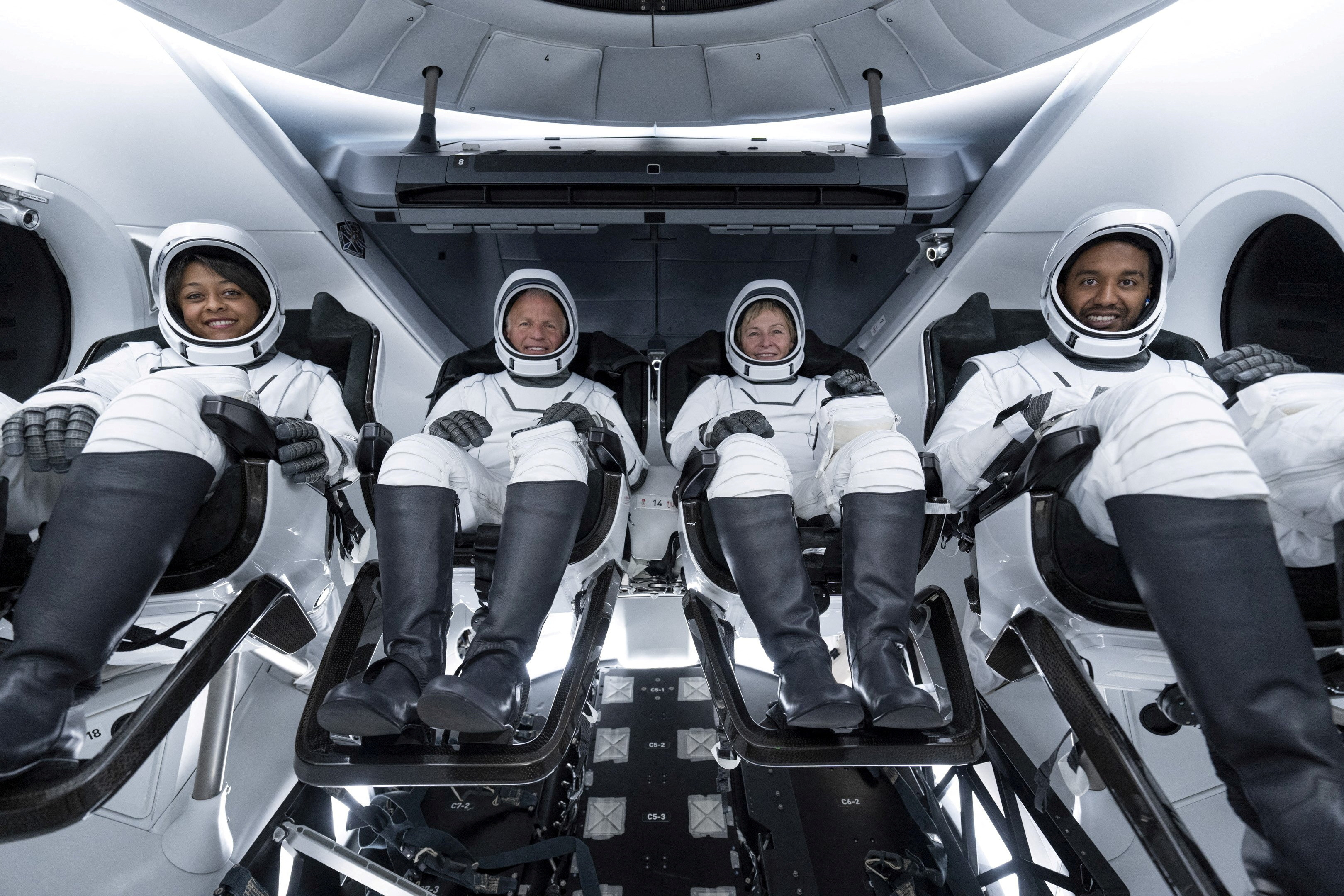 Saudi astronauts Rayyanah Barnawi and Ali Al Qarni, with their crew Peggy Whitson and John Shoffner pose for a photo ahead of their mission to the ISS