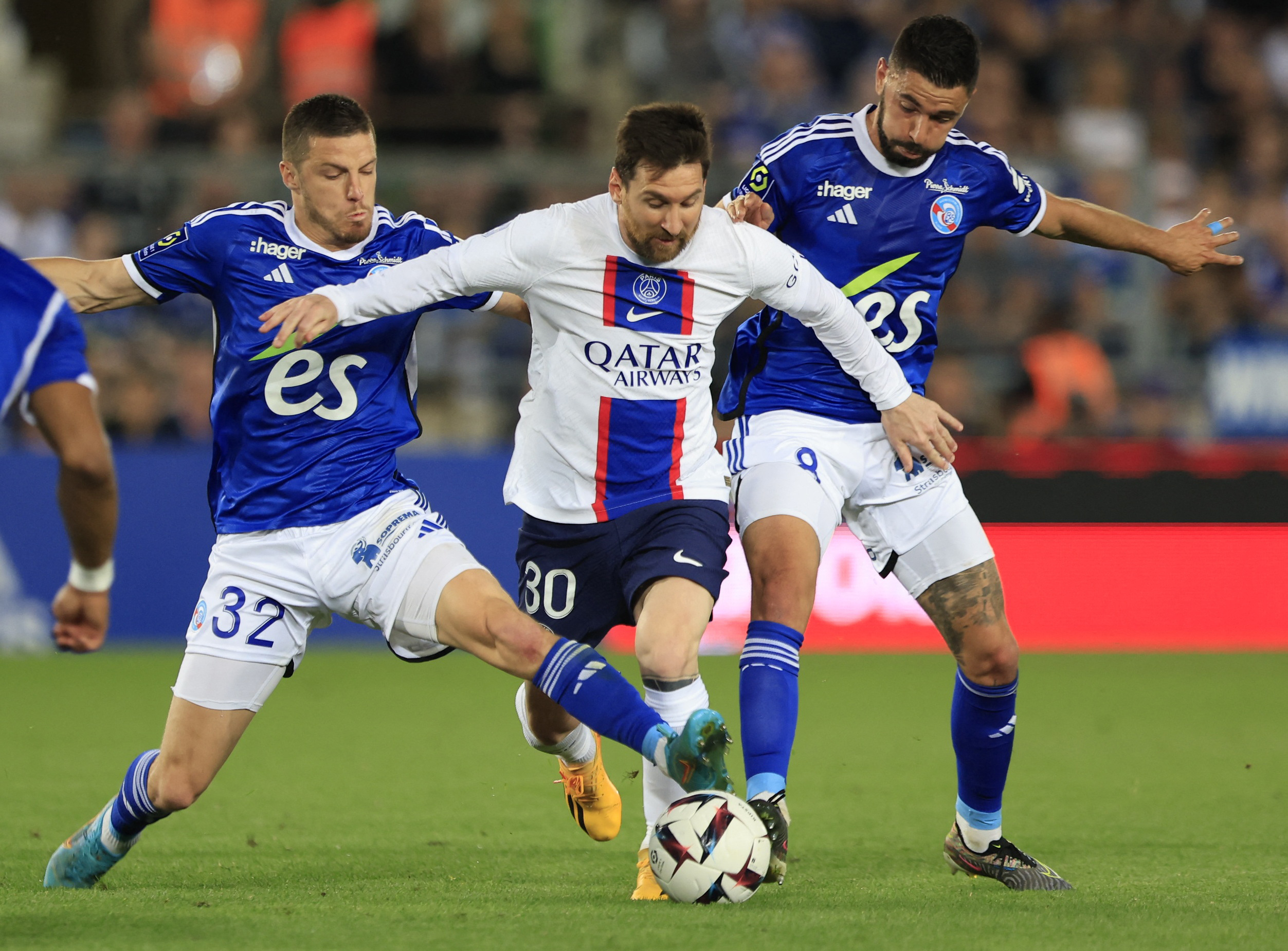Messi in action with RC Strasbourg’s Frederic Guilbert