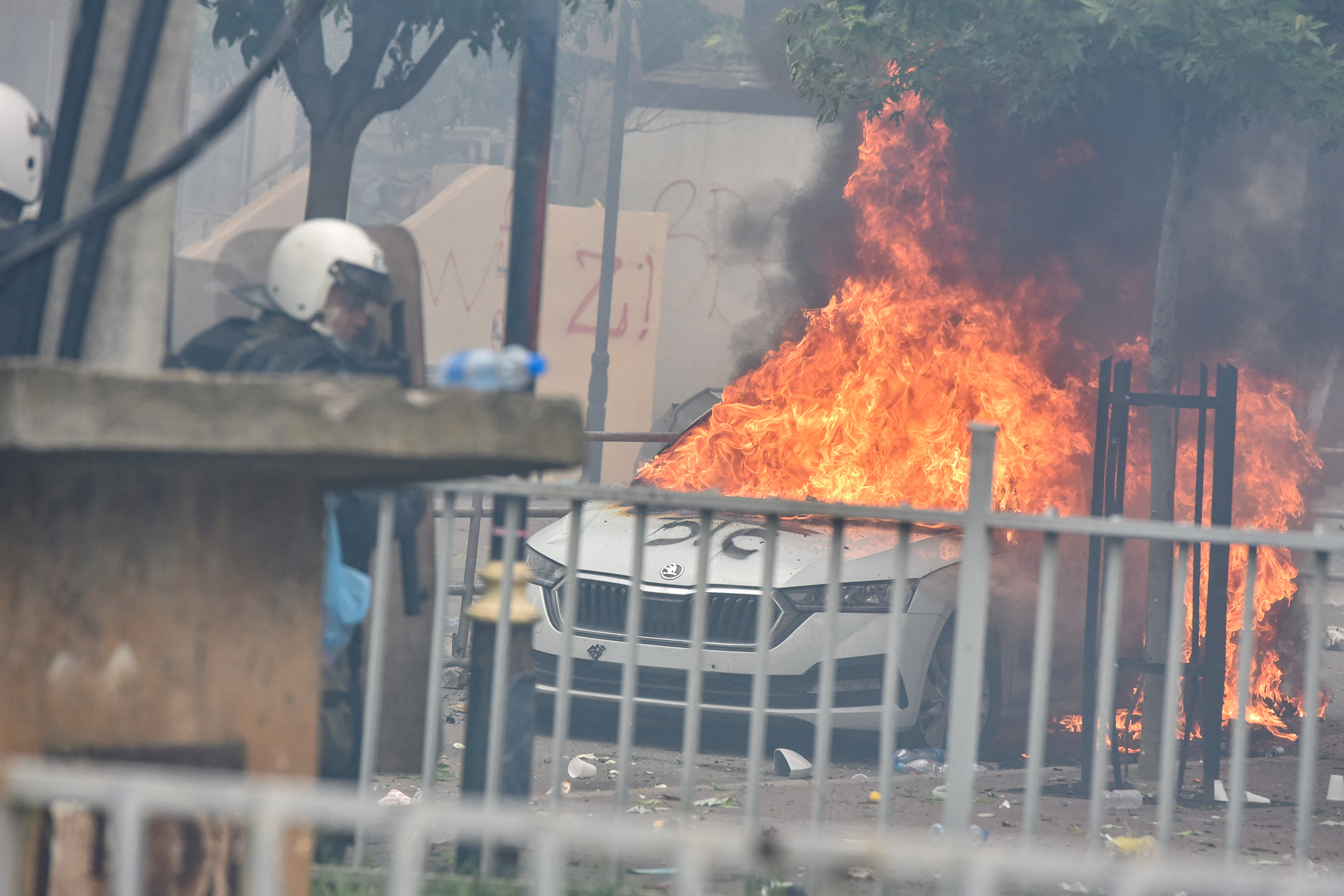 A car burns after NATO Kosovo Force (KFOR) soldiers clashed with local Kosovo Serb protesters at the entrance of the municipality office, in the town of Zvecan