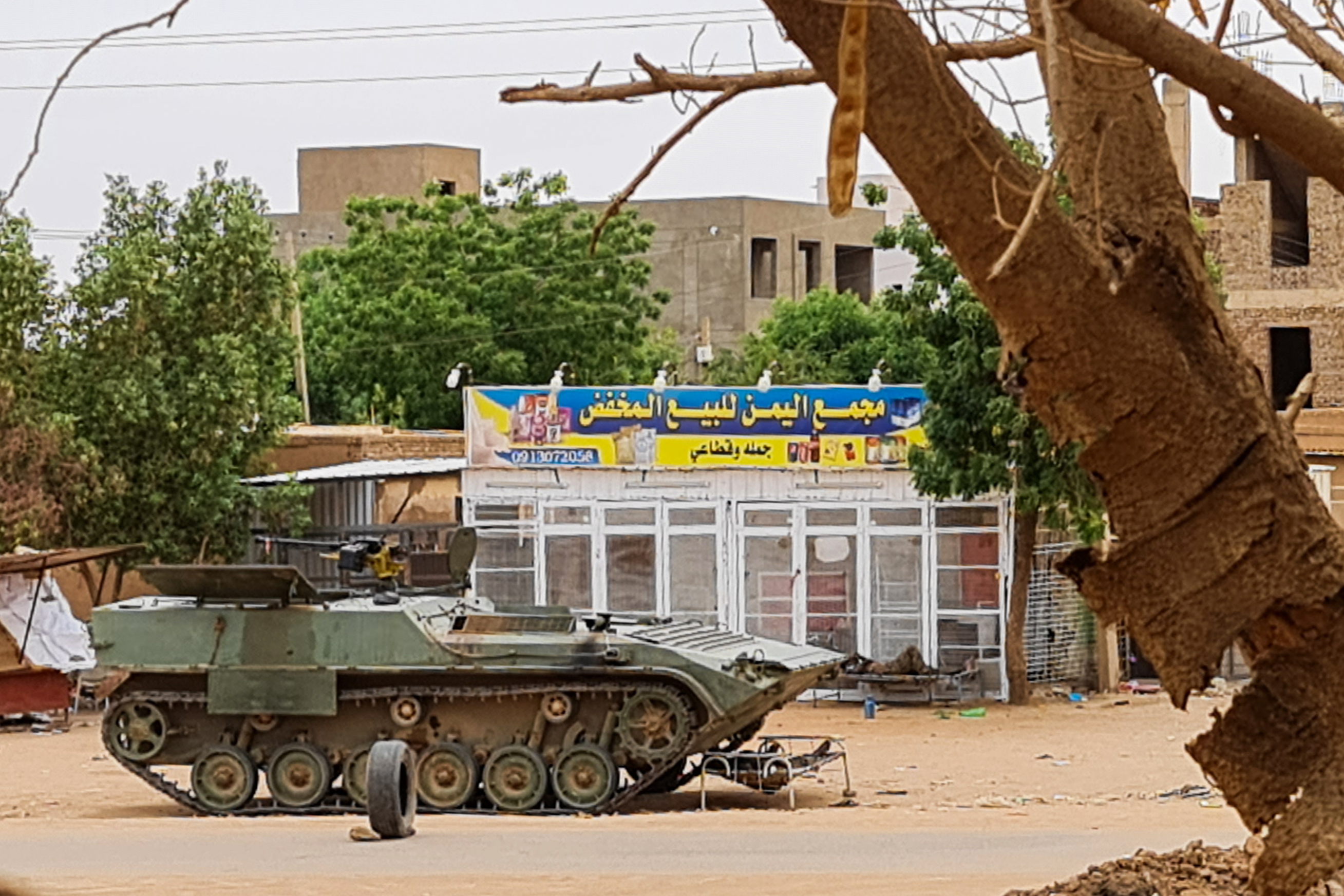 Sudanese Army soldiers rest near a tank at a checkpoint in Khartoum on April 30, 2023, as clashes continue in war-torn Sudan [AFP]
