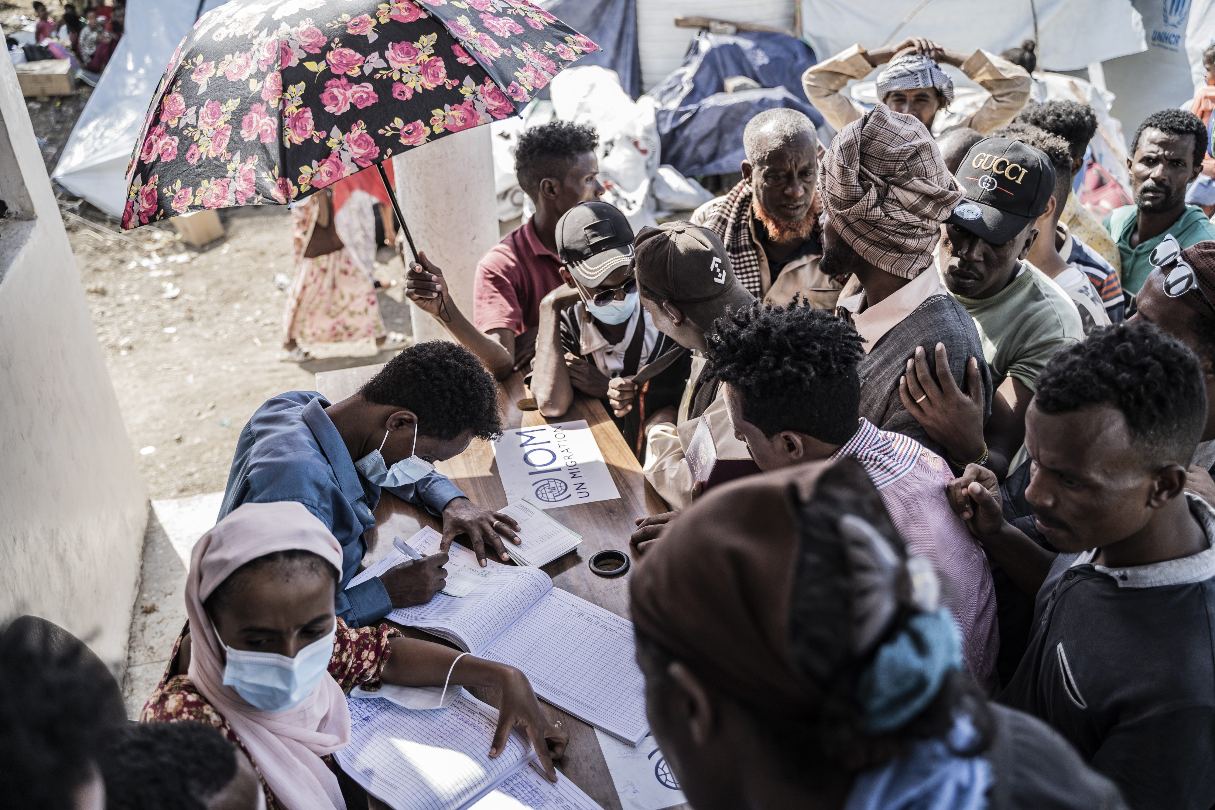 Workers register refugees who crossed from Sudan to Ethiopia at the IOM