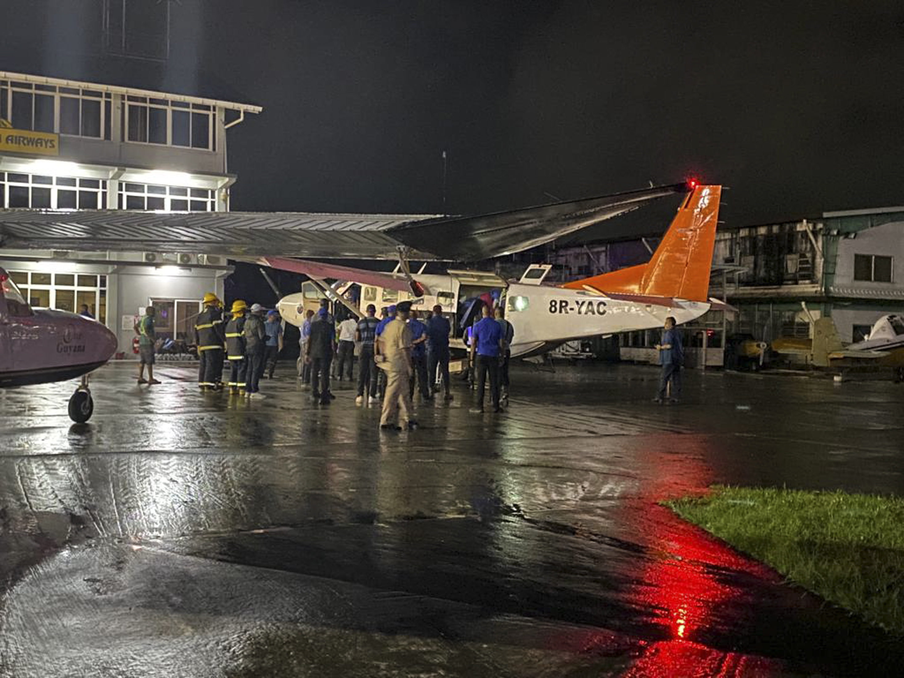 Children rescued during a Mahdia secondary school dormitory fire are transferred by medical personnel, firefighters and policemen to hospitals in Georgetown, Guyana
