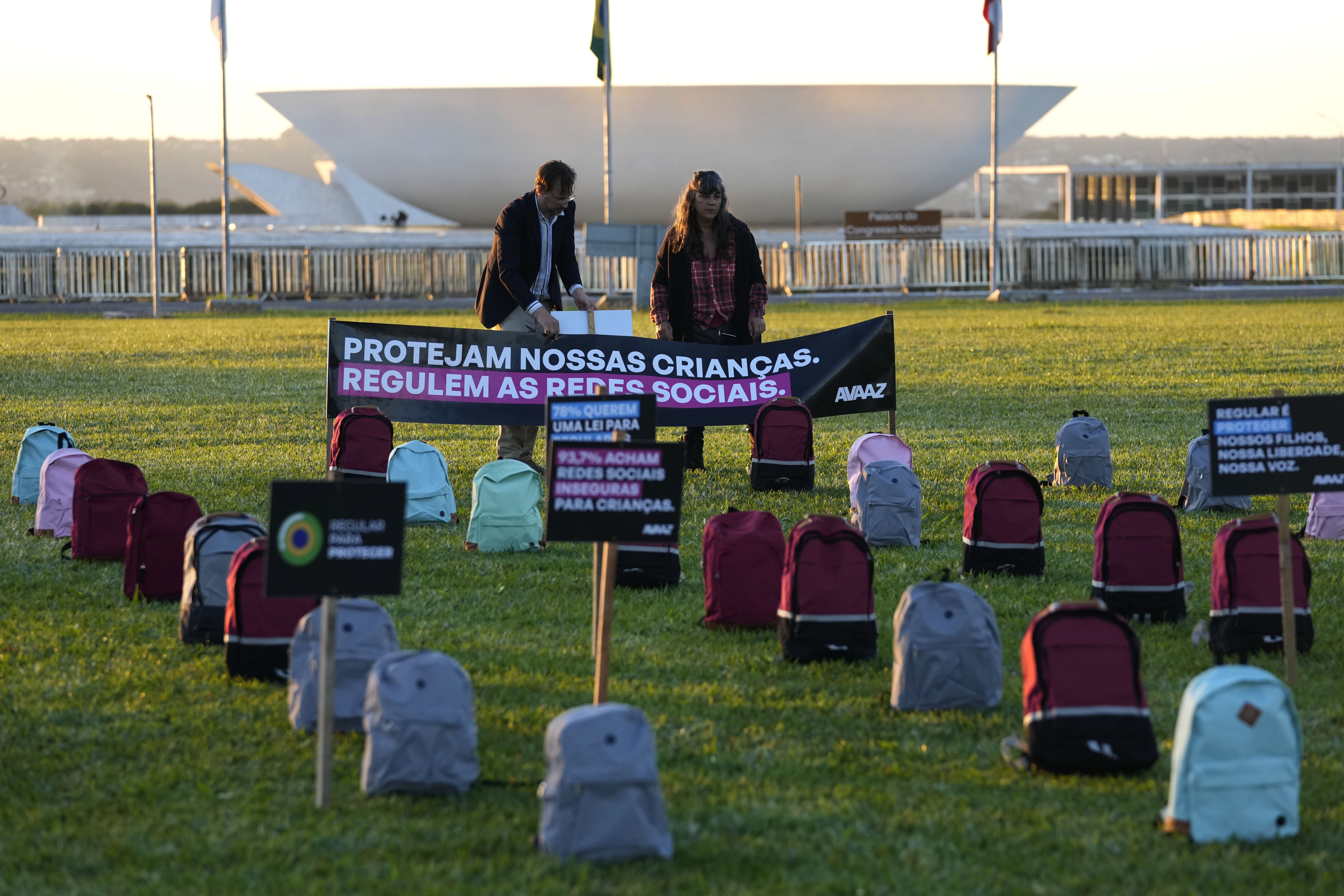 Protesters place signs that read, ‘Protect our children. Regulate the social networks’, outside Brazil’s Congress as it considers a bill to regulate internet platforms