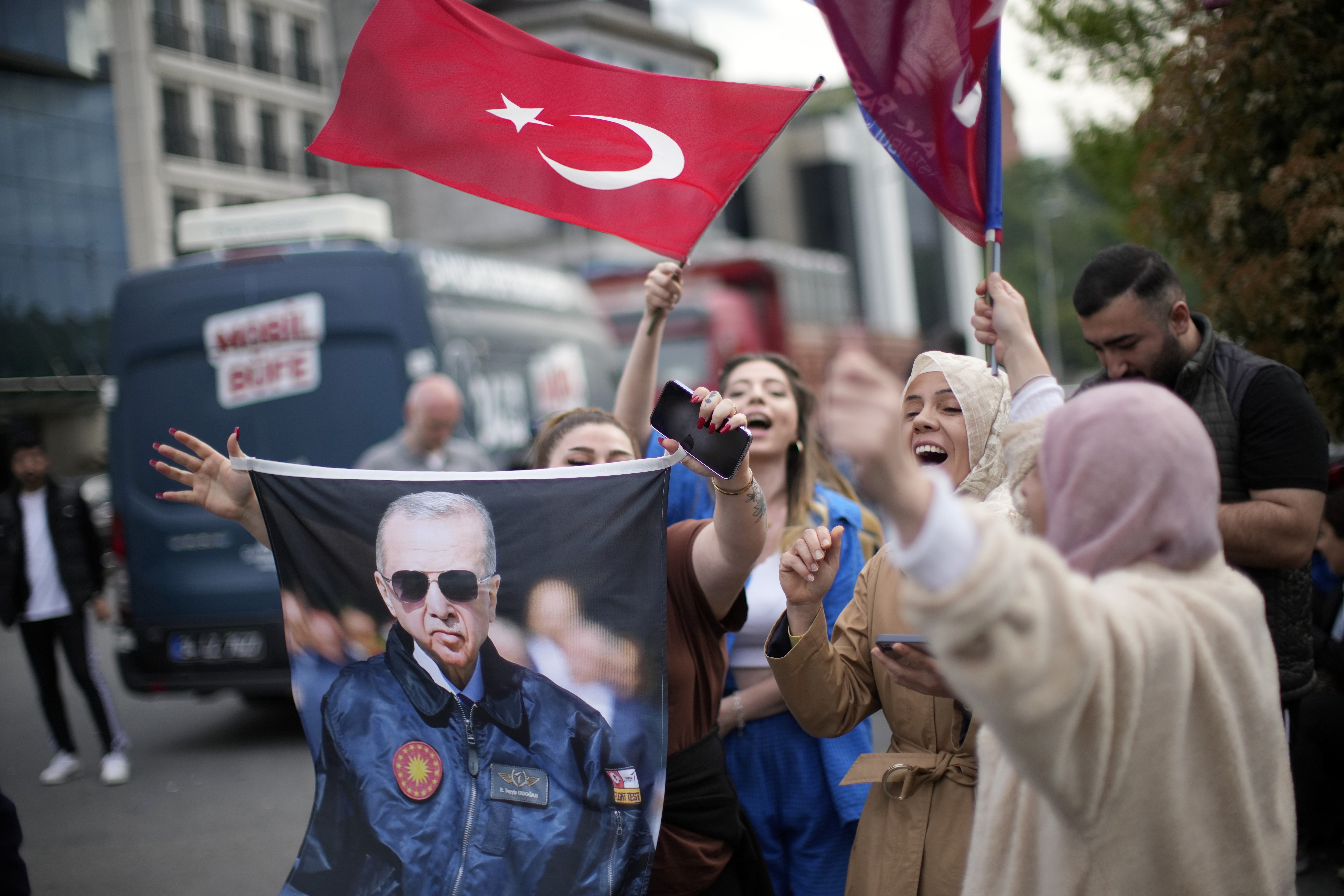 Supporters of President Recep Tayyip Erdogan cheer outside the headquarters of AK Party in Istanbul