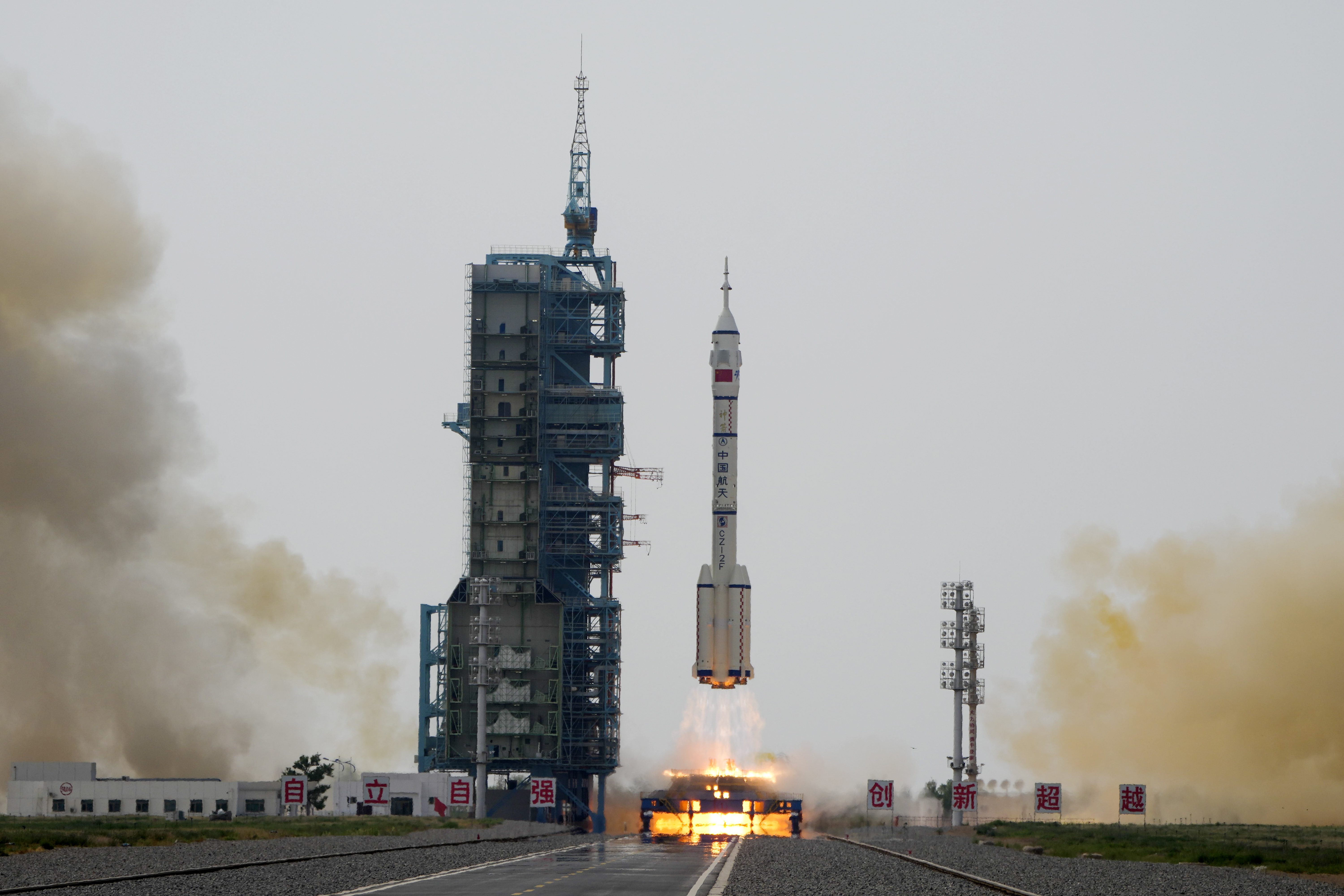 A Long March rocket carrying the Shenzhou-16 spaceship lifts off from the Jiuquan Satellite Launch Center in northwestern China. There are flames beneath the rocket and lots of smoke