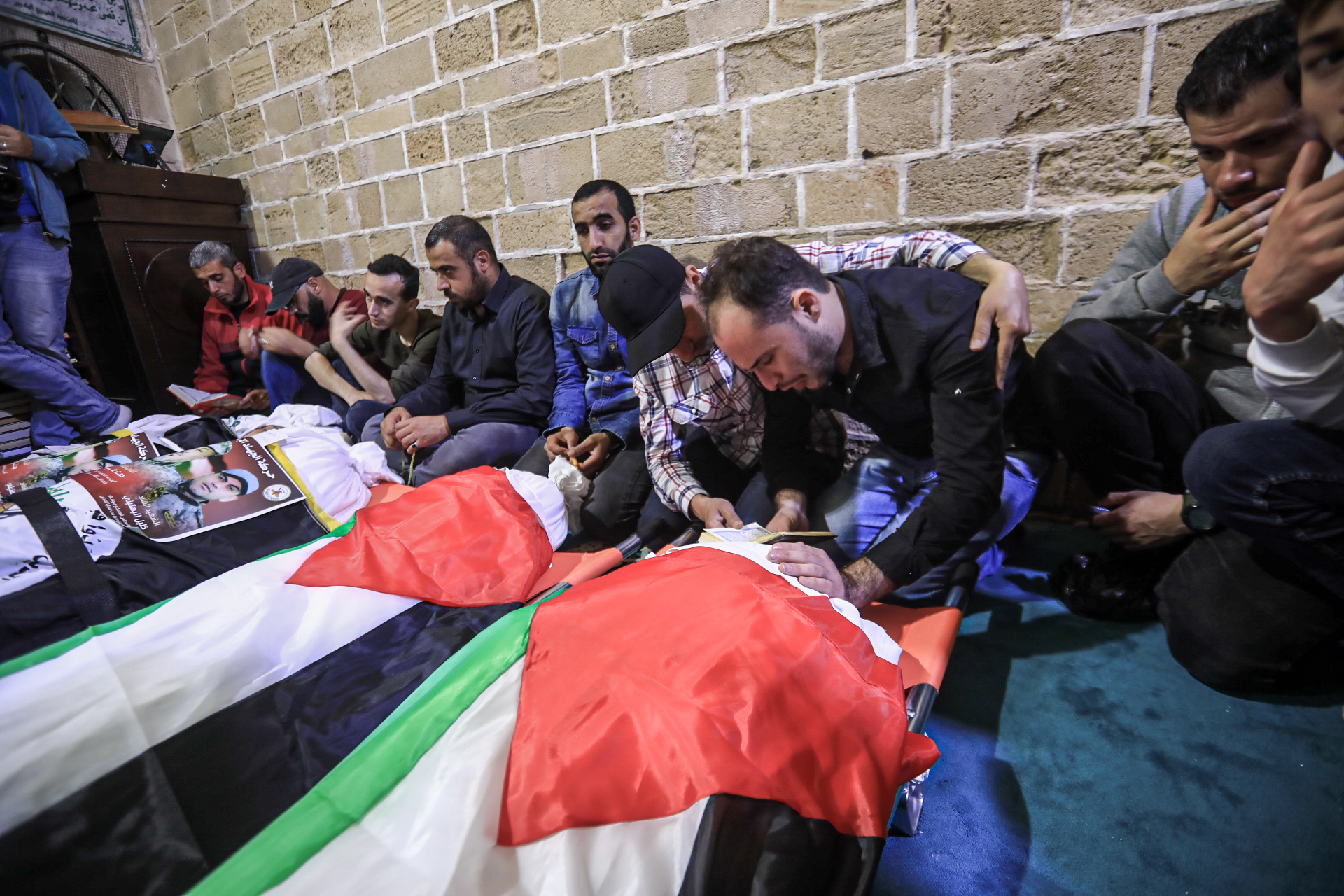 Dania Adass_s finance mourns her body in the mass funeral in Al-Omari mosque