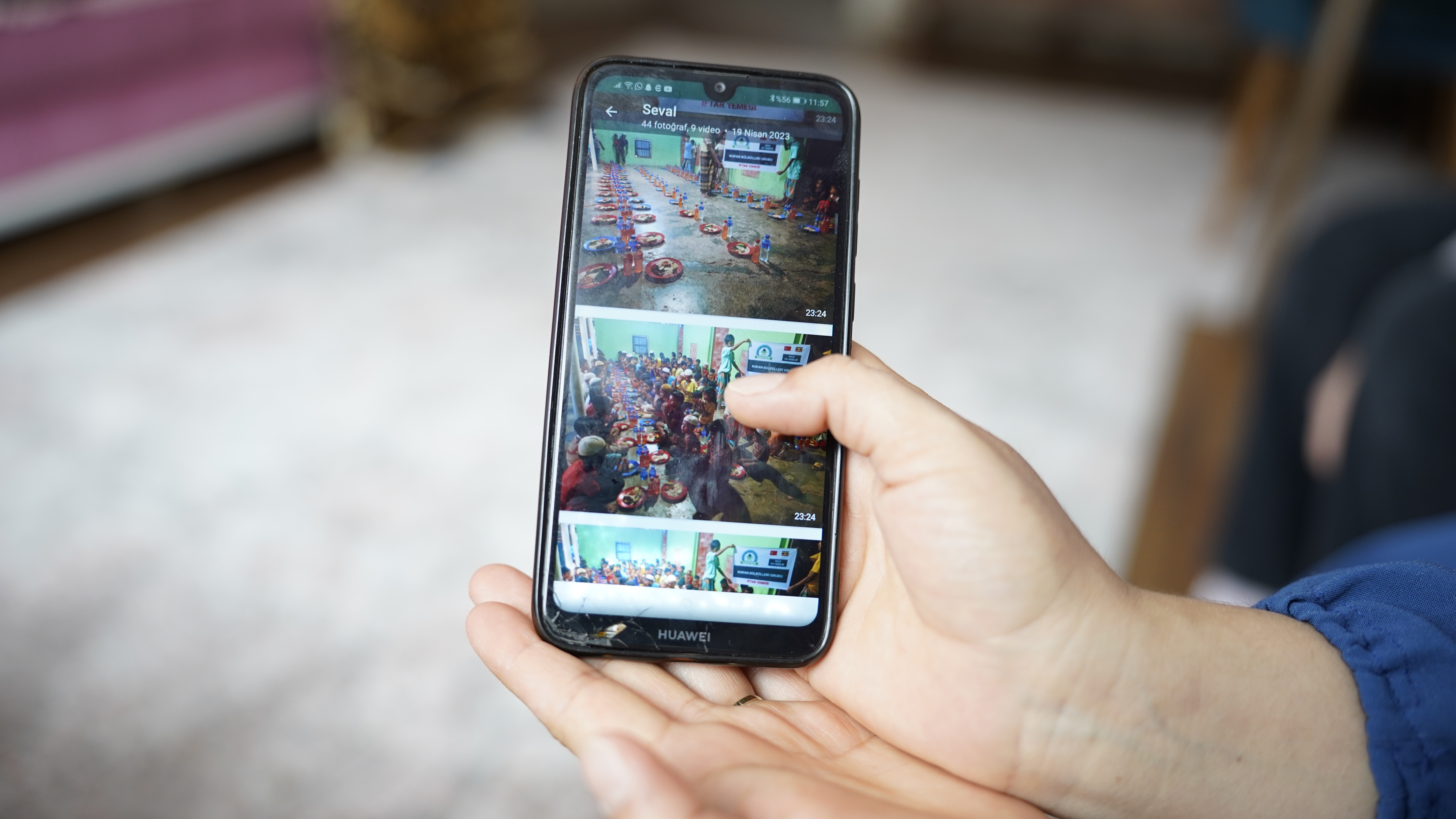 A woman shows a photo on her mobile phone