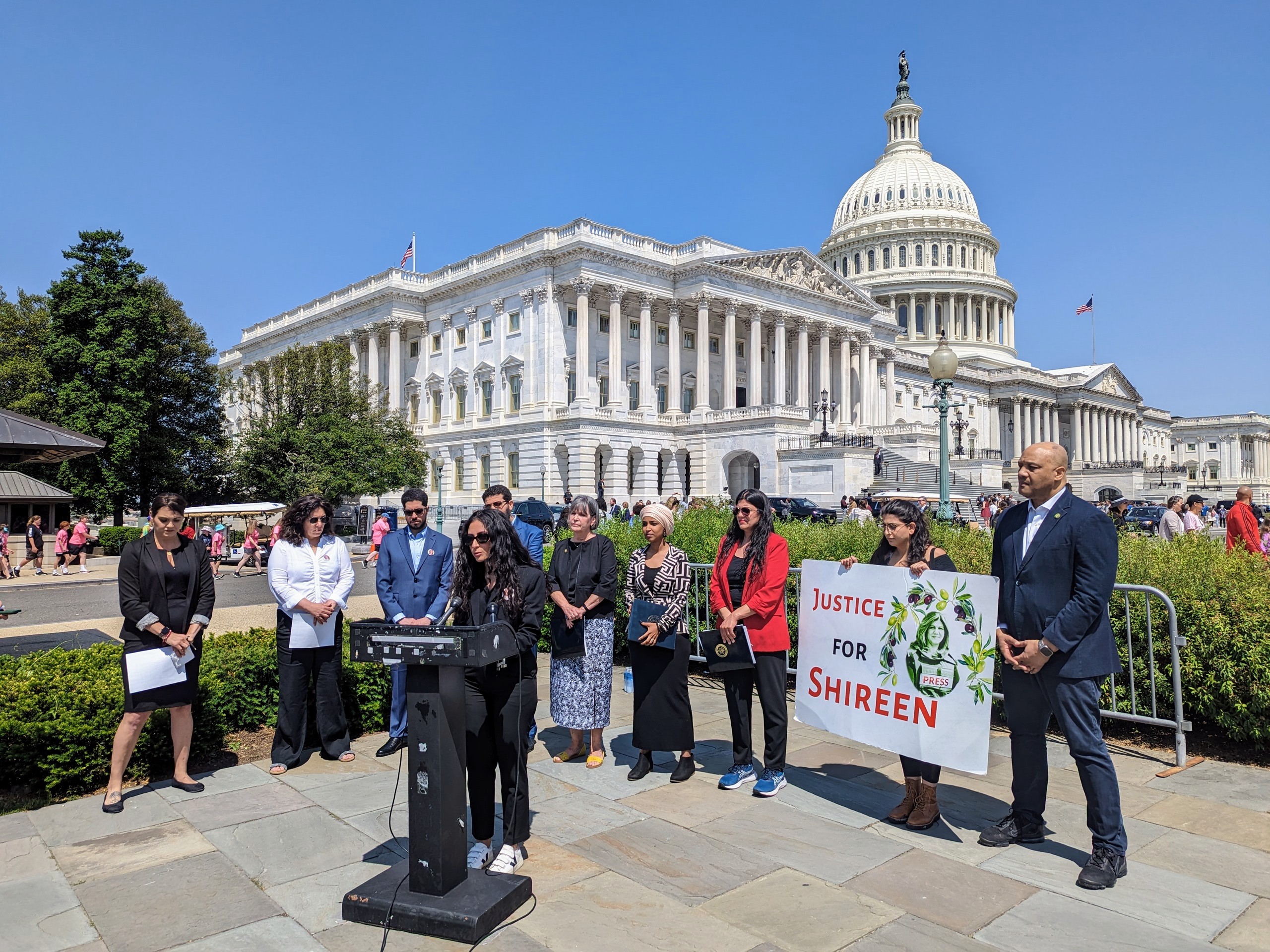 Lina Abu Akleh, flanked by US lawmakers, advocates and other family members, speaks outside the US Capitol on May 18