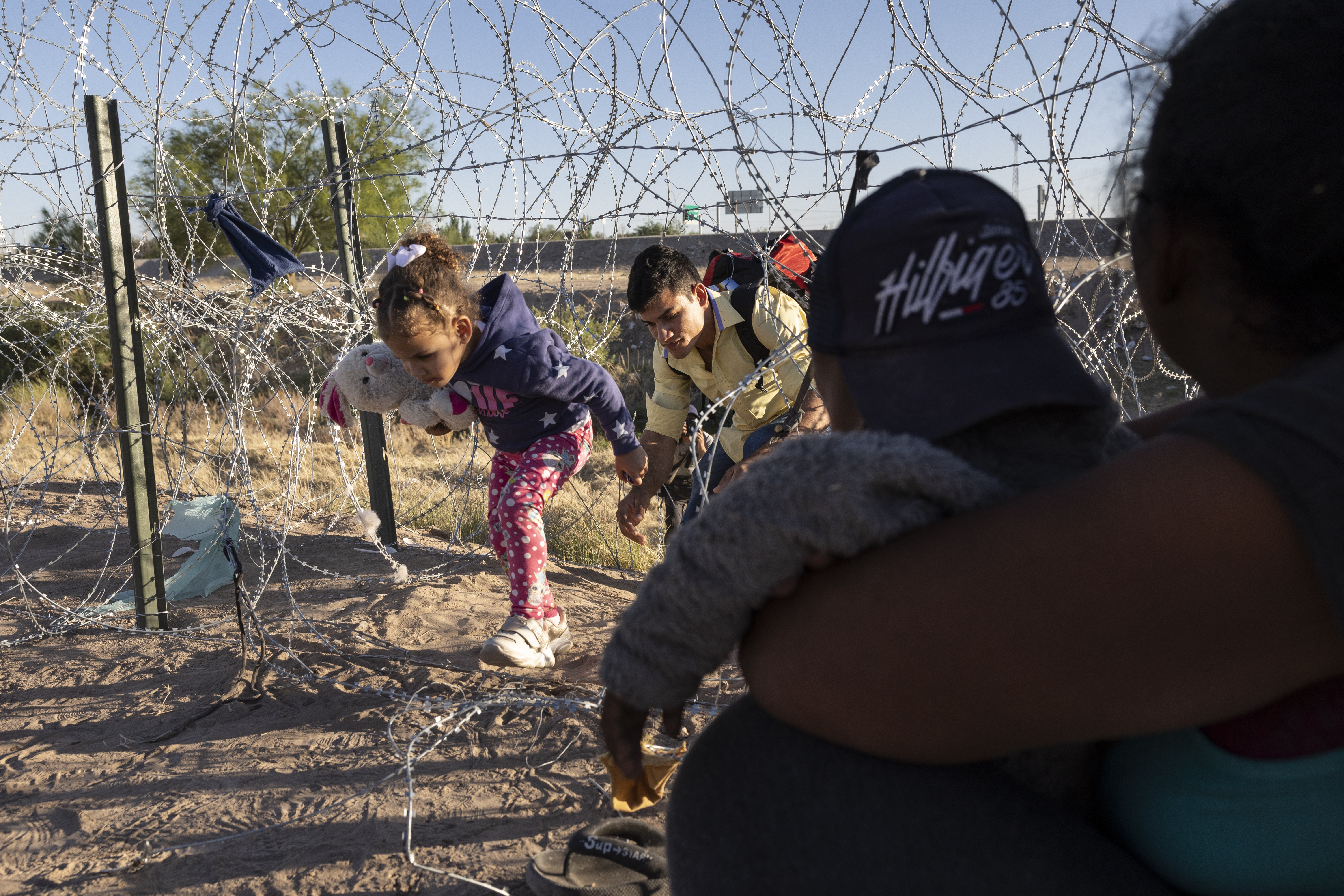 Families cross from Mexico into the US to seek asylum, in El Paso, Texas, May 8