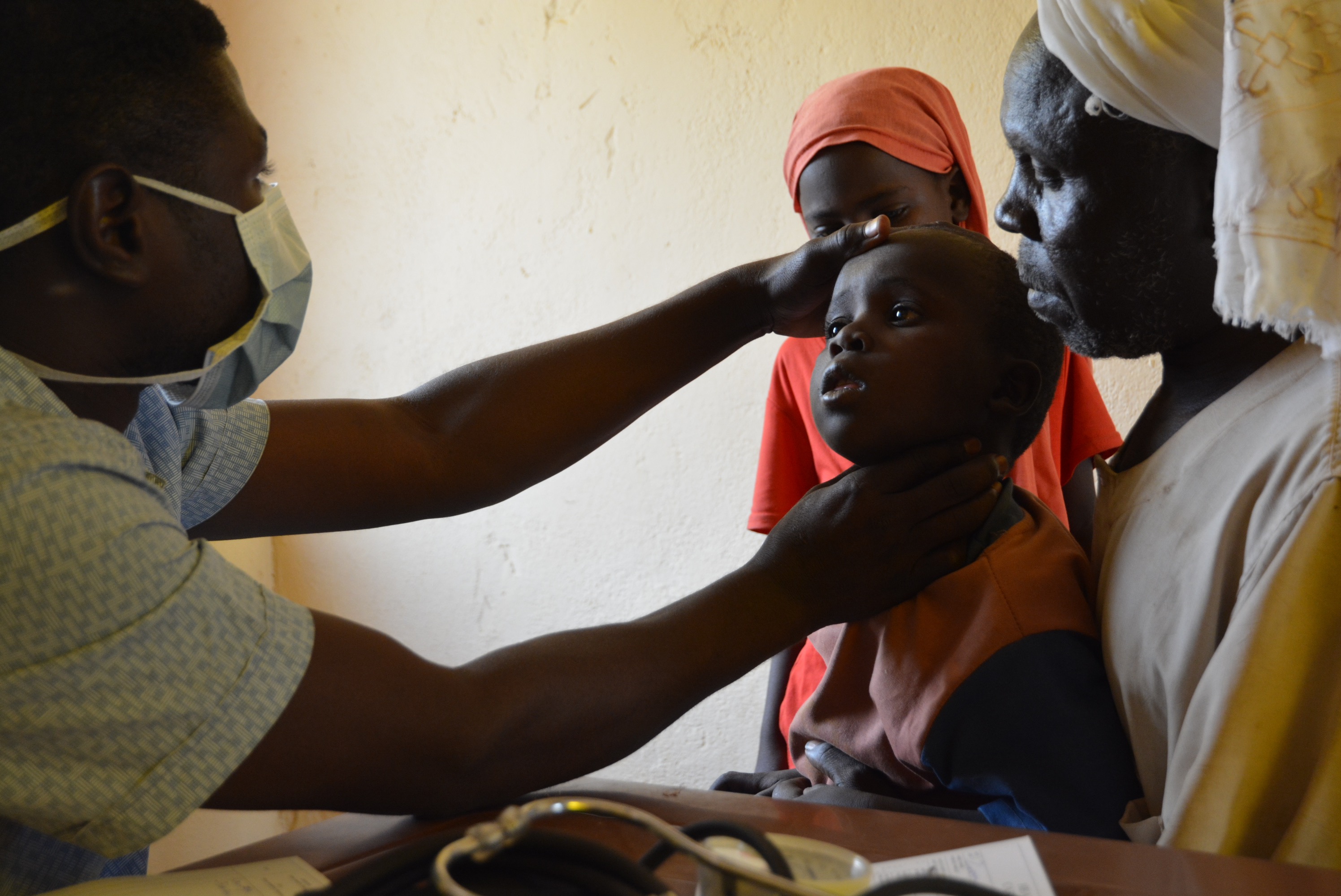 A medic treats a young patient at a health centre in Zamzam IDP camp. March 2023